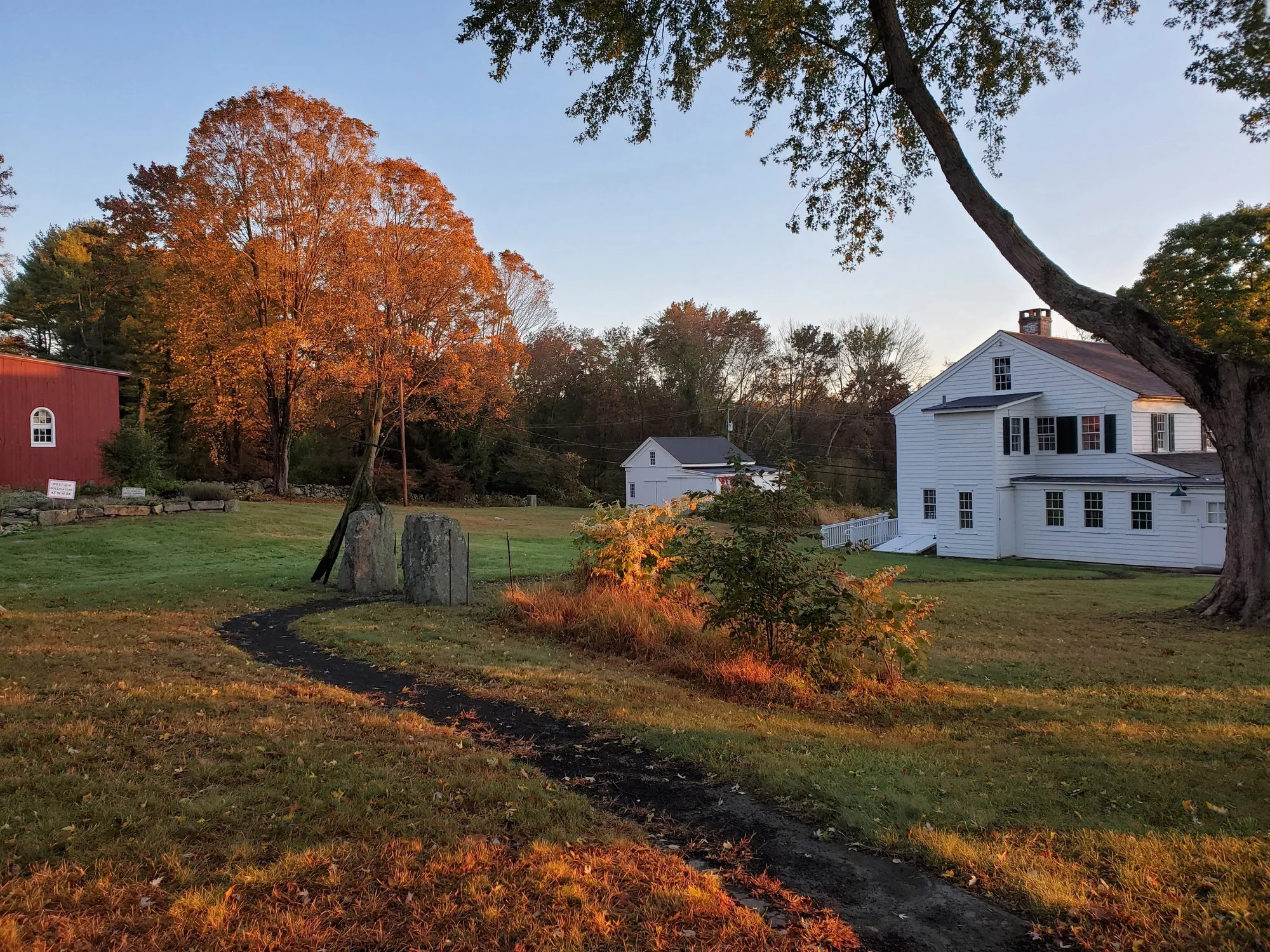 A path across the homestead grounds at sunrise, fall 2020