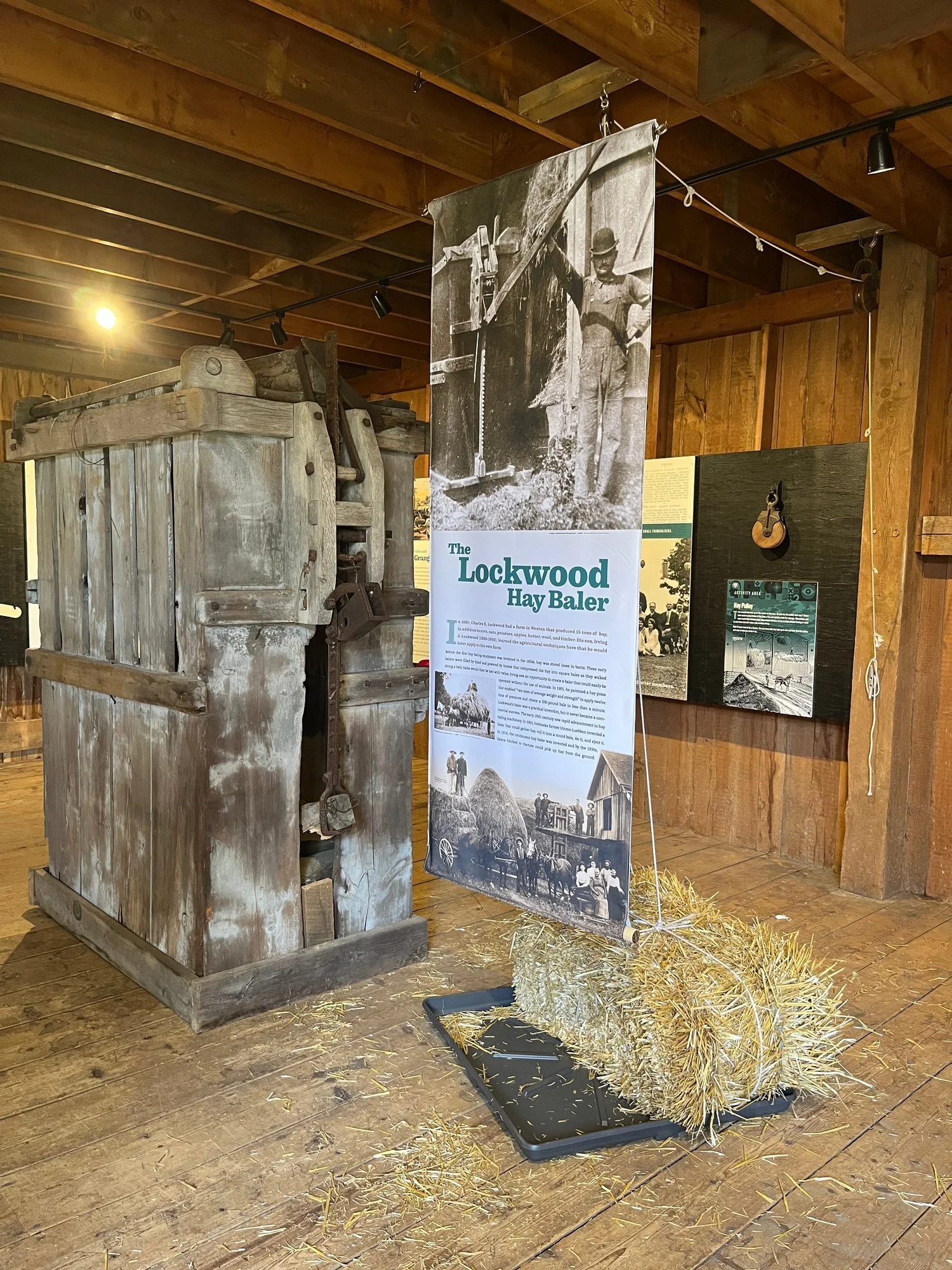 The Lockwood hay baler, with a hay bale and explanatory banner.
