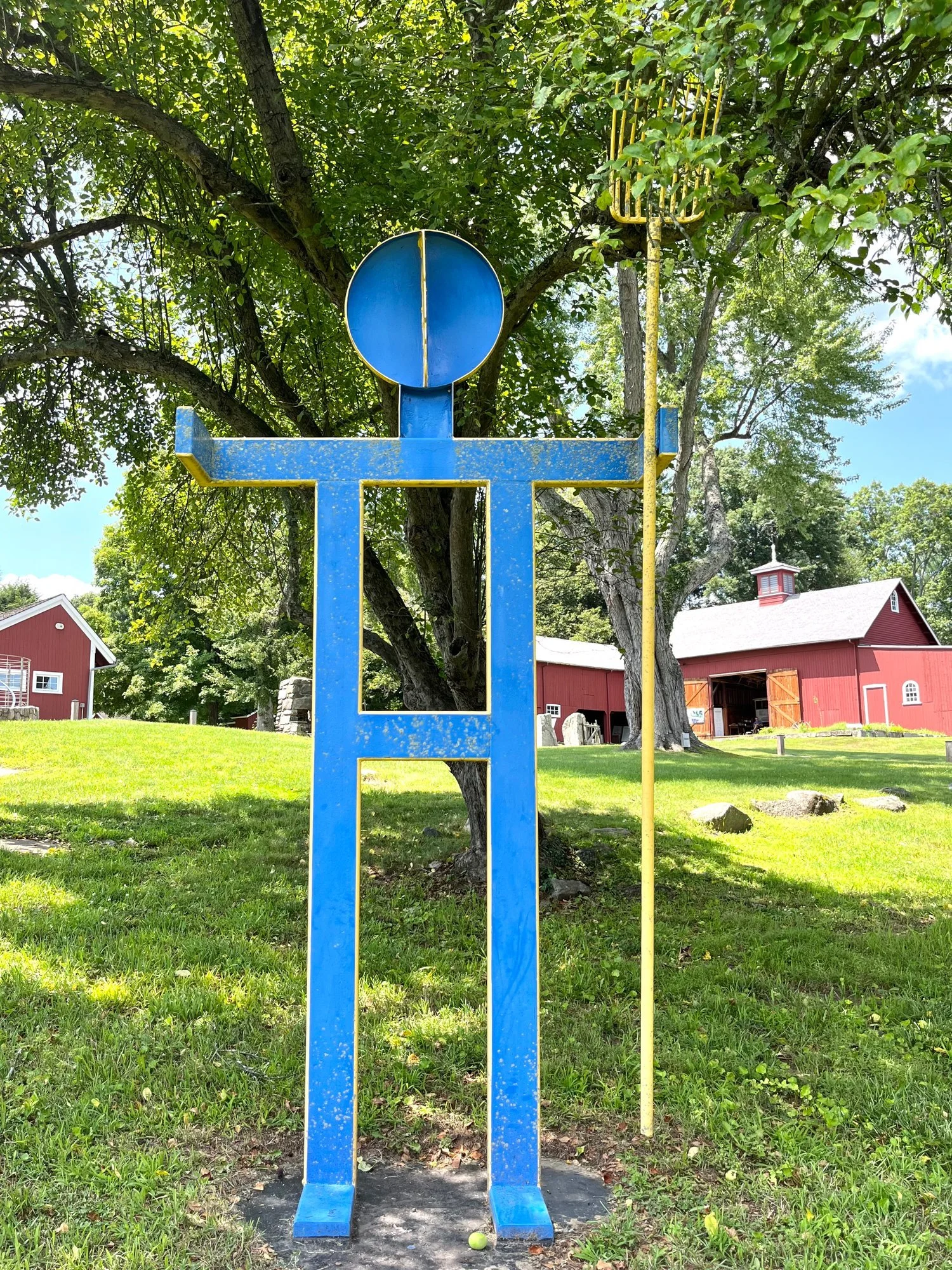 A blue metal figure in the sculpture garden, summer 2026