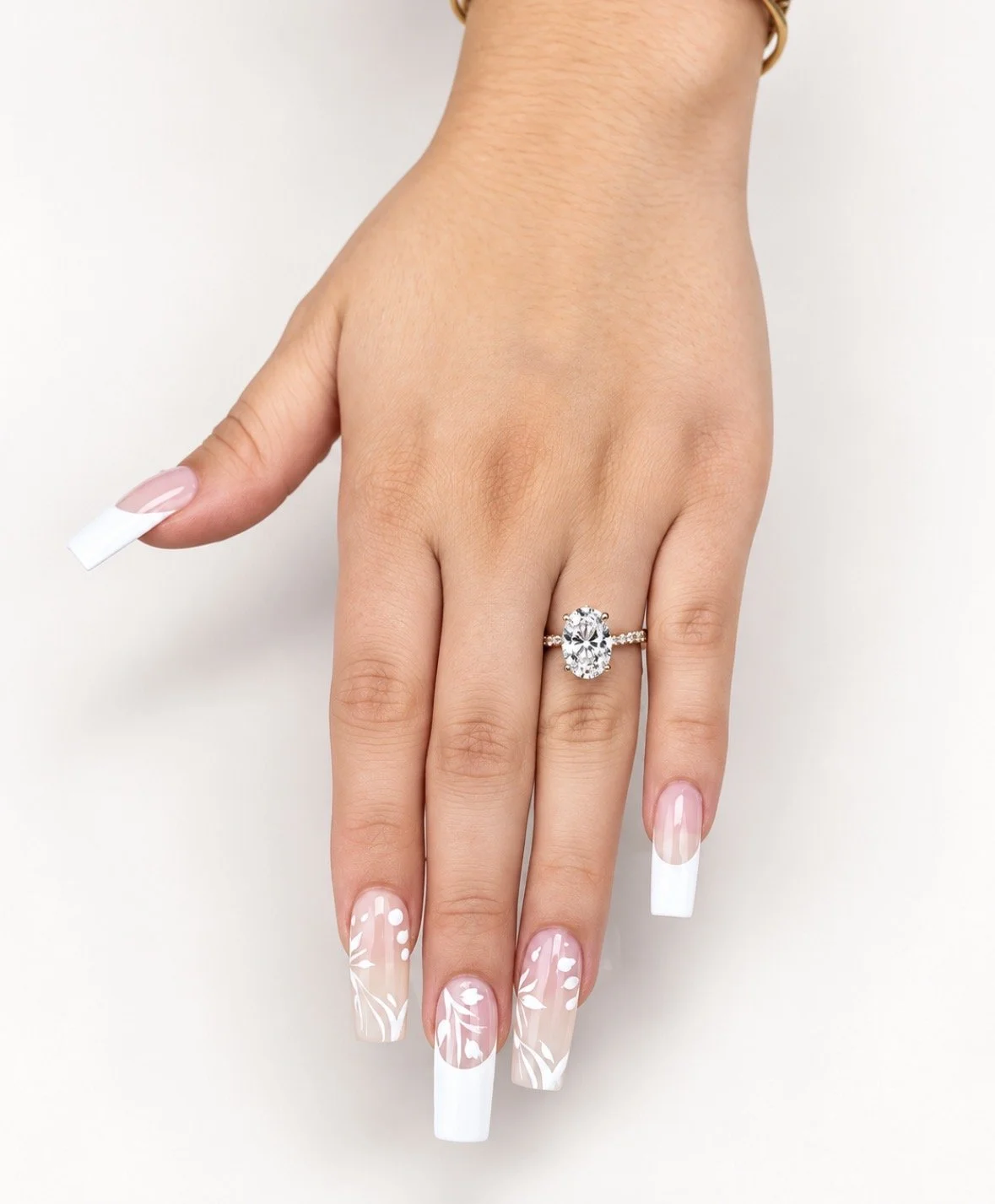 Close-up of, long nails, beautifully manicured with white French tips and floral nail art.
