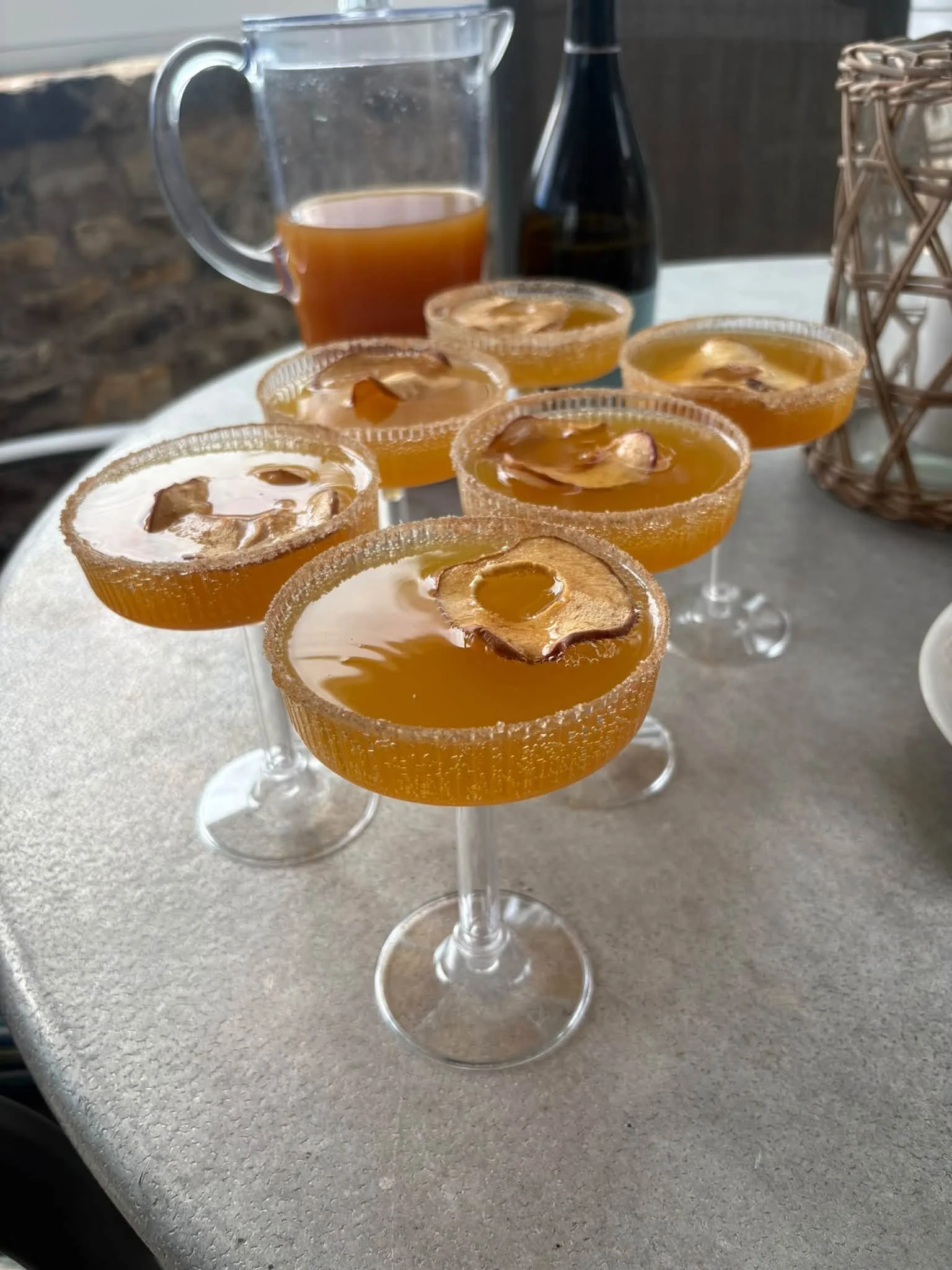 Apple cocktails, finished with a sugared rim and a little garnish.