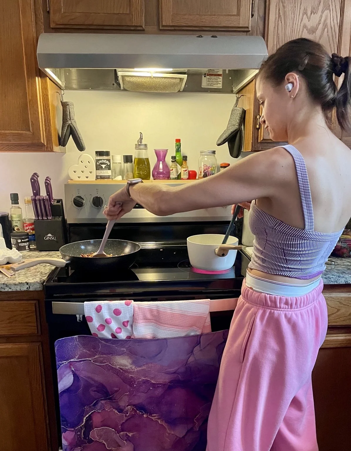 Megan at the stove, preparing food with care.