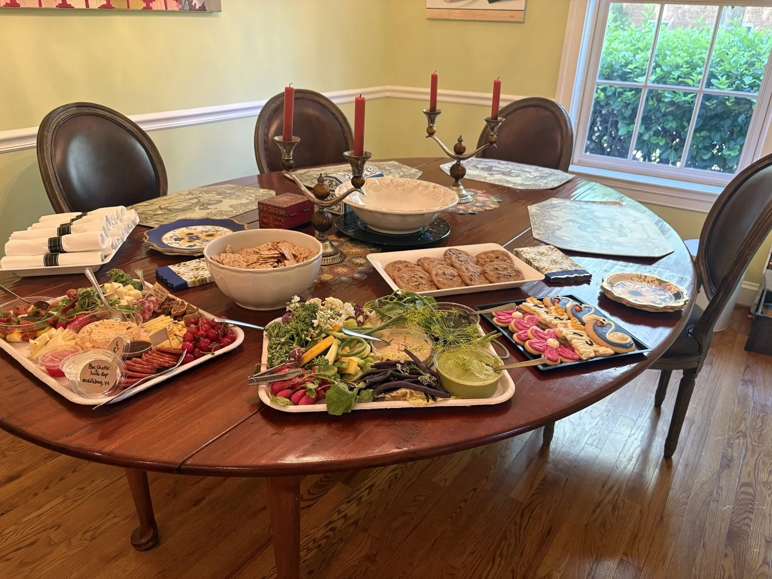 A welcoming grazing table with savory bites, fresh vegetables and something sweet.