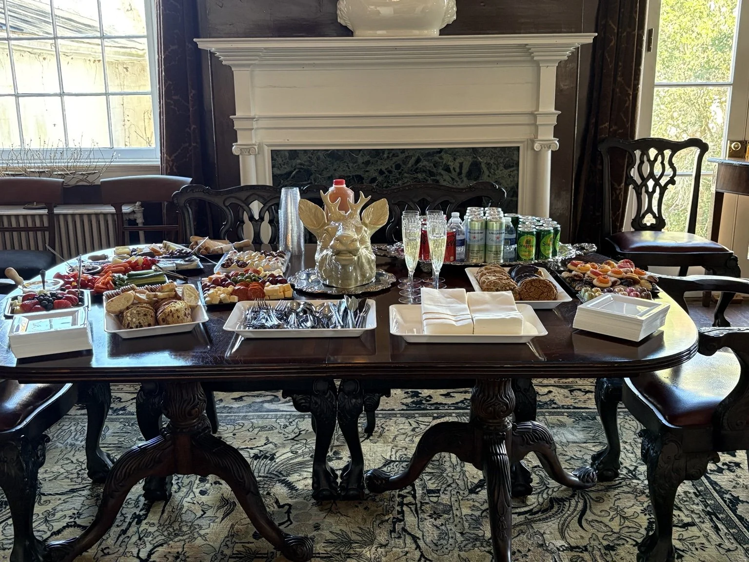 A dining-room gathering with thoughtfully arranged food, drinks and sweets.