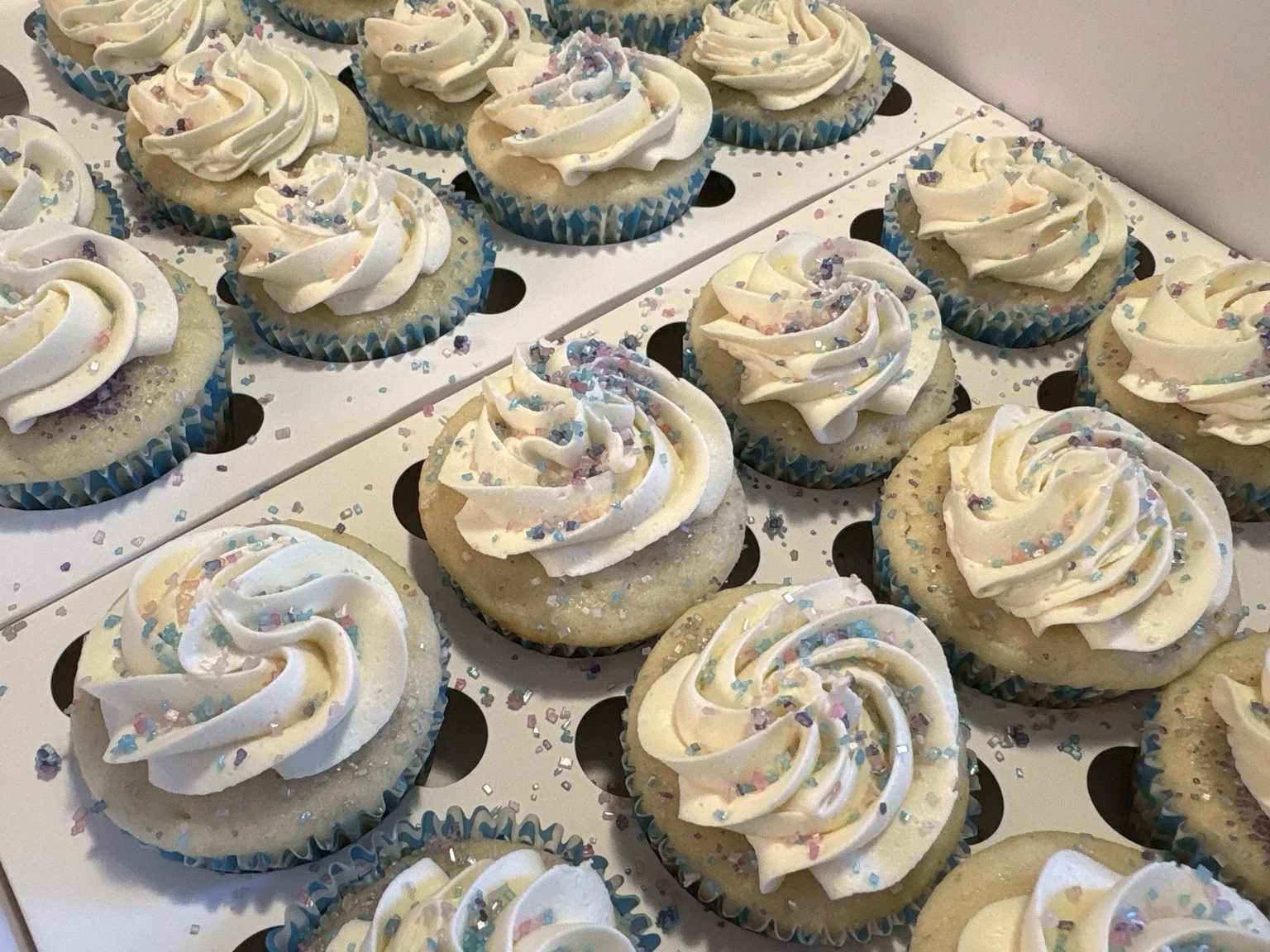 Celebration cupcakes with swirled frosting and pastel sprinkles.