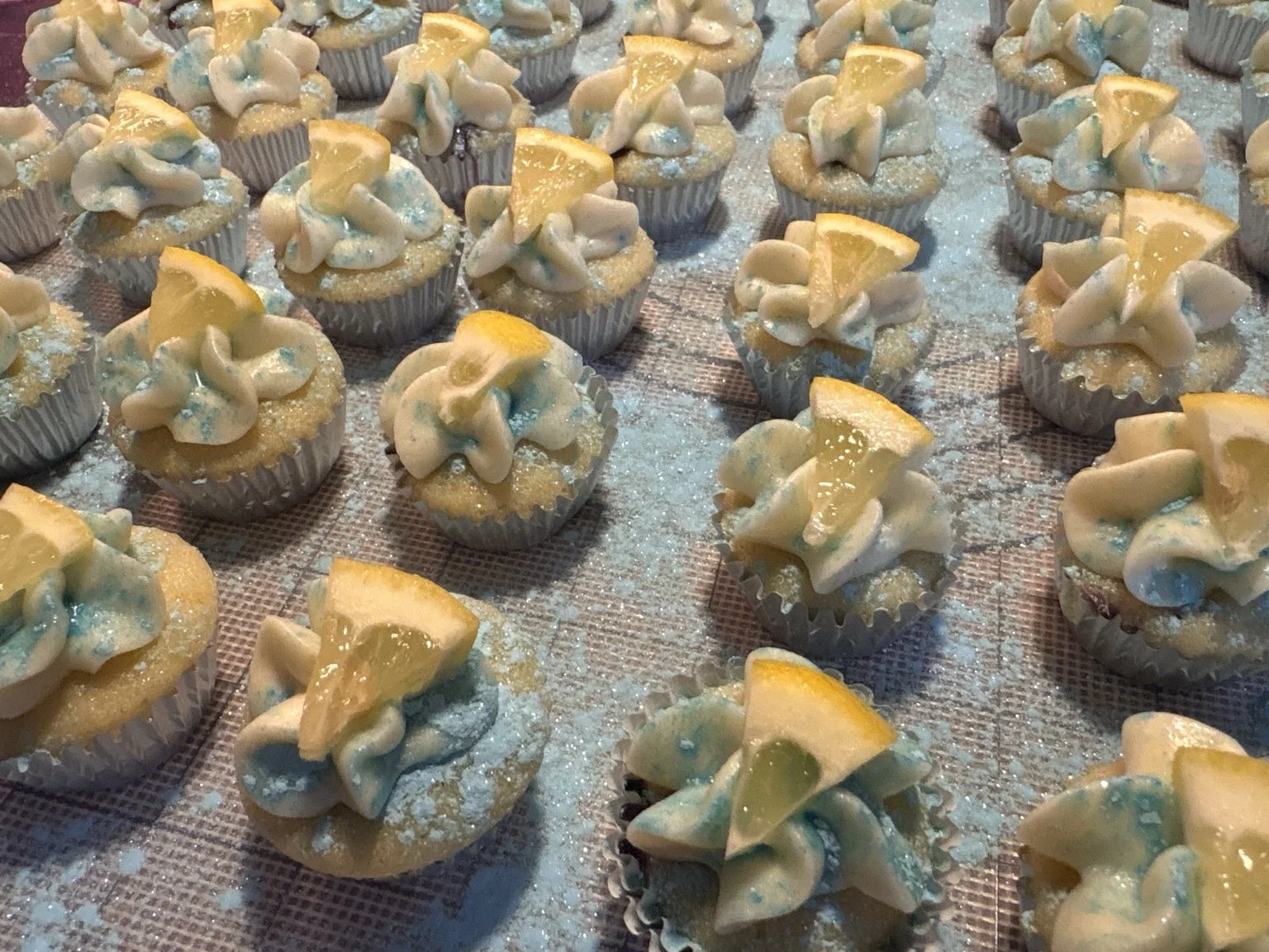 Mini cupcakes with lemon wedges and a little sparkle.