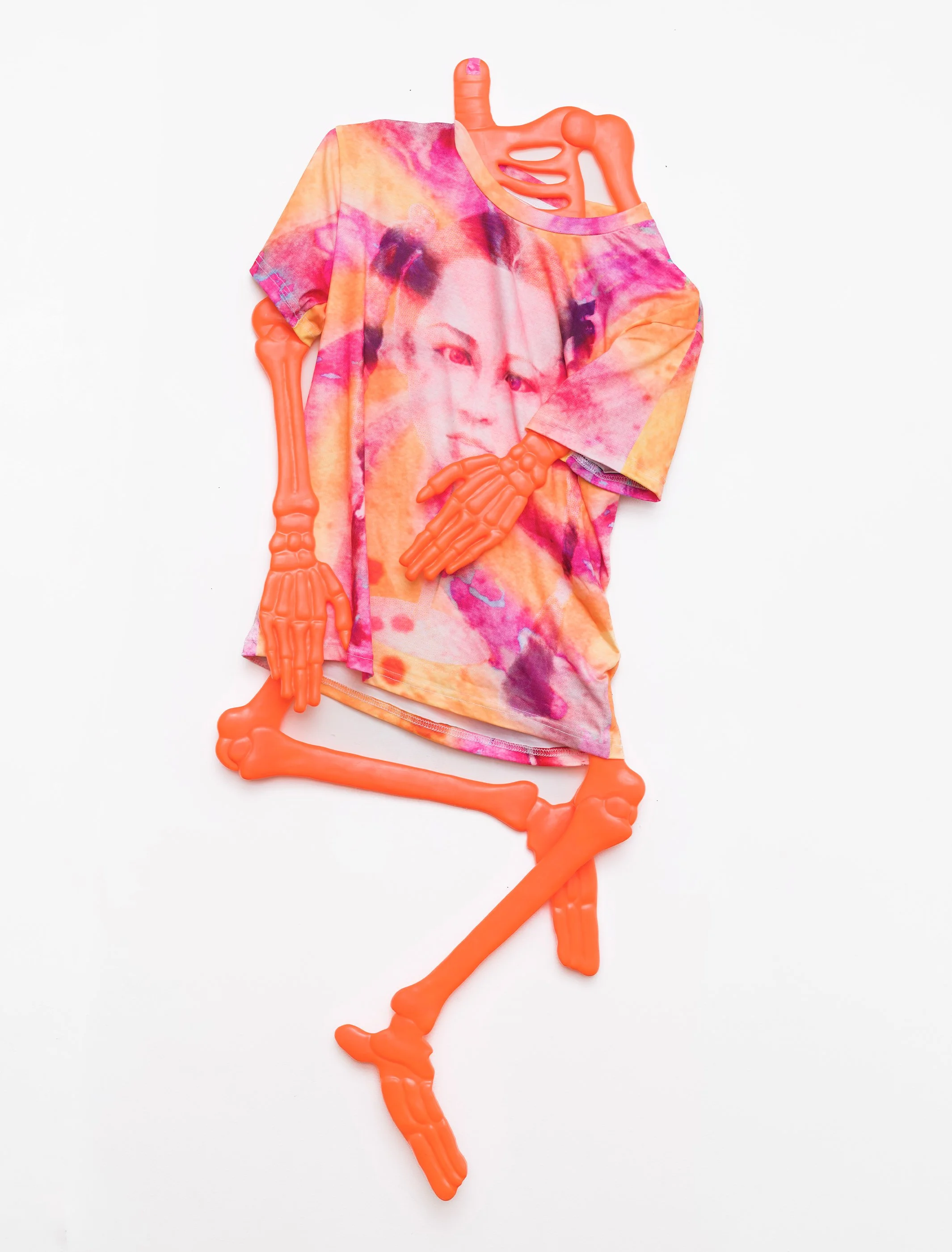 Licker Consumption (t-shirt dress), 2026. Custom all over print lollipop girl polyester t-shirt size XS, plastic skeleton. 4 ft tall from the neck down.

