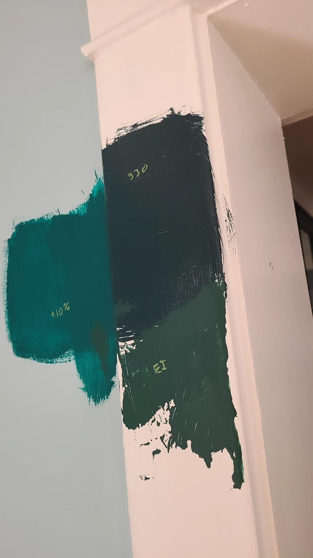 Paint color swatches labeled +10%, 330, and EI on a white wall.