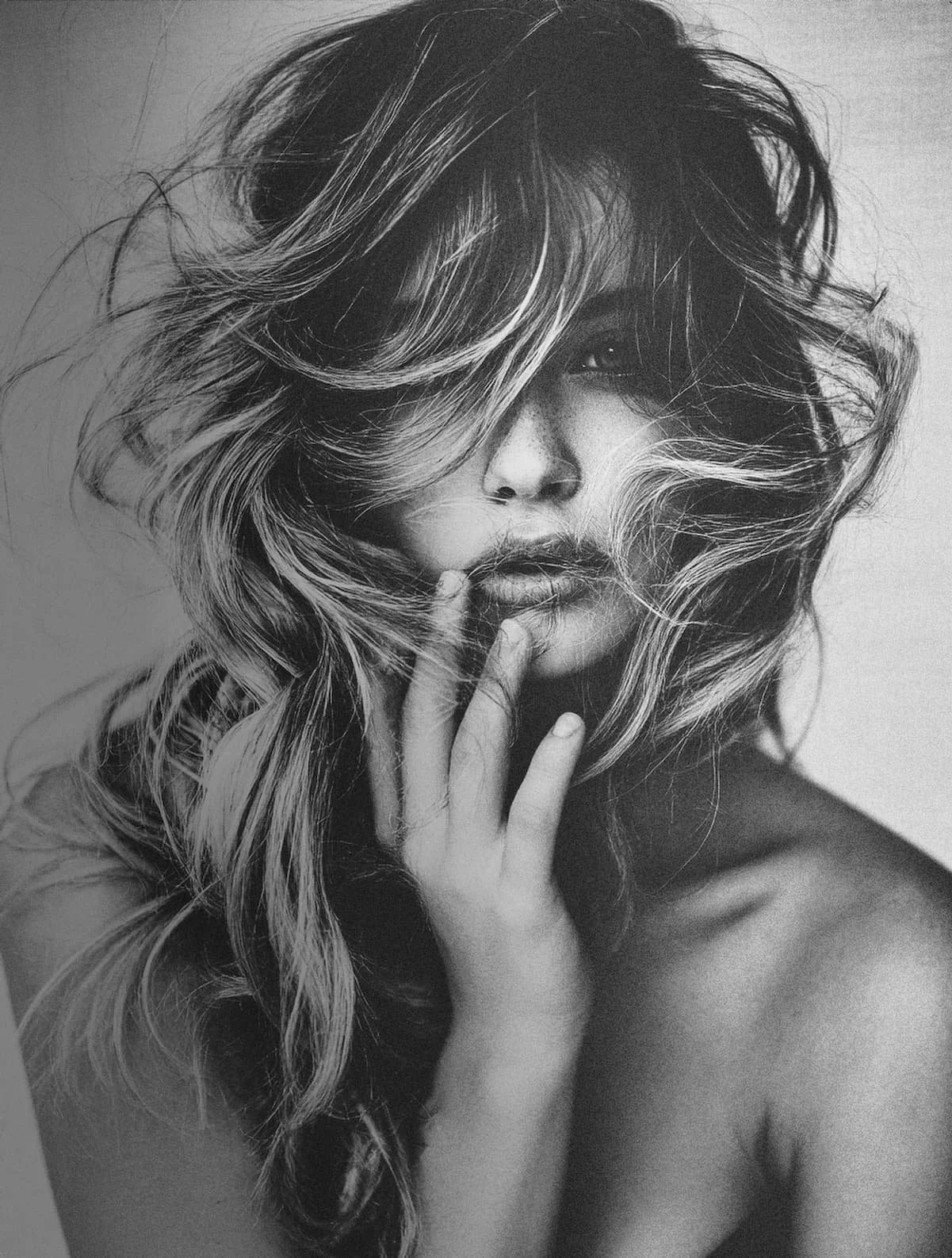 Black and white portrait of a woman with voluminous, tousled hair
