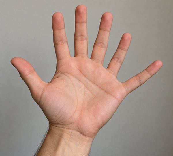 A human hand with fingers spread apart against a neutral background.