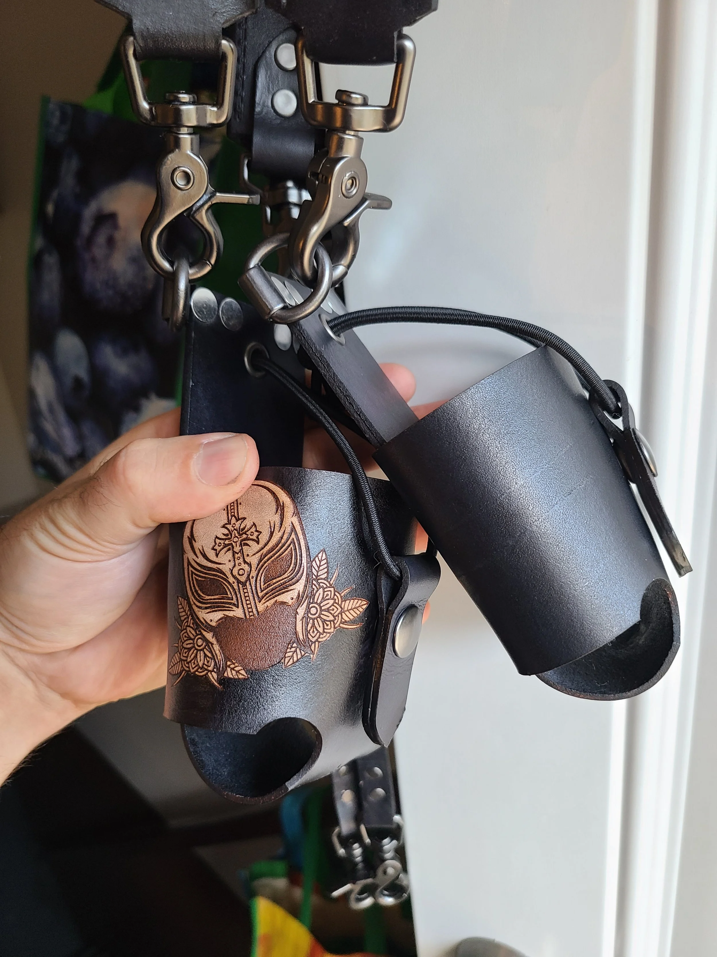 Close-up of a custom Awl Star Leather radio basket showing personalized decorative leatherwork and harness hardware.
