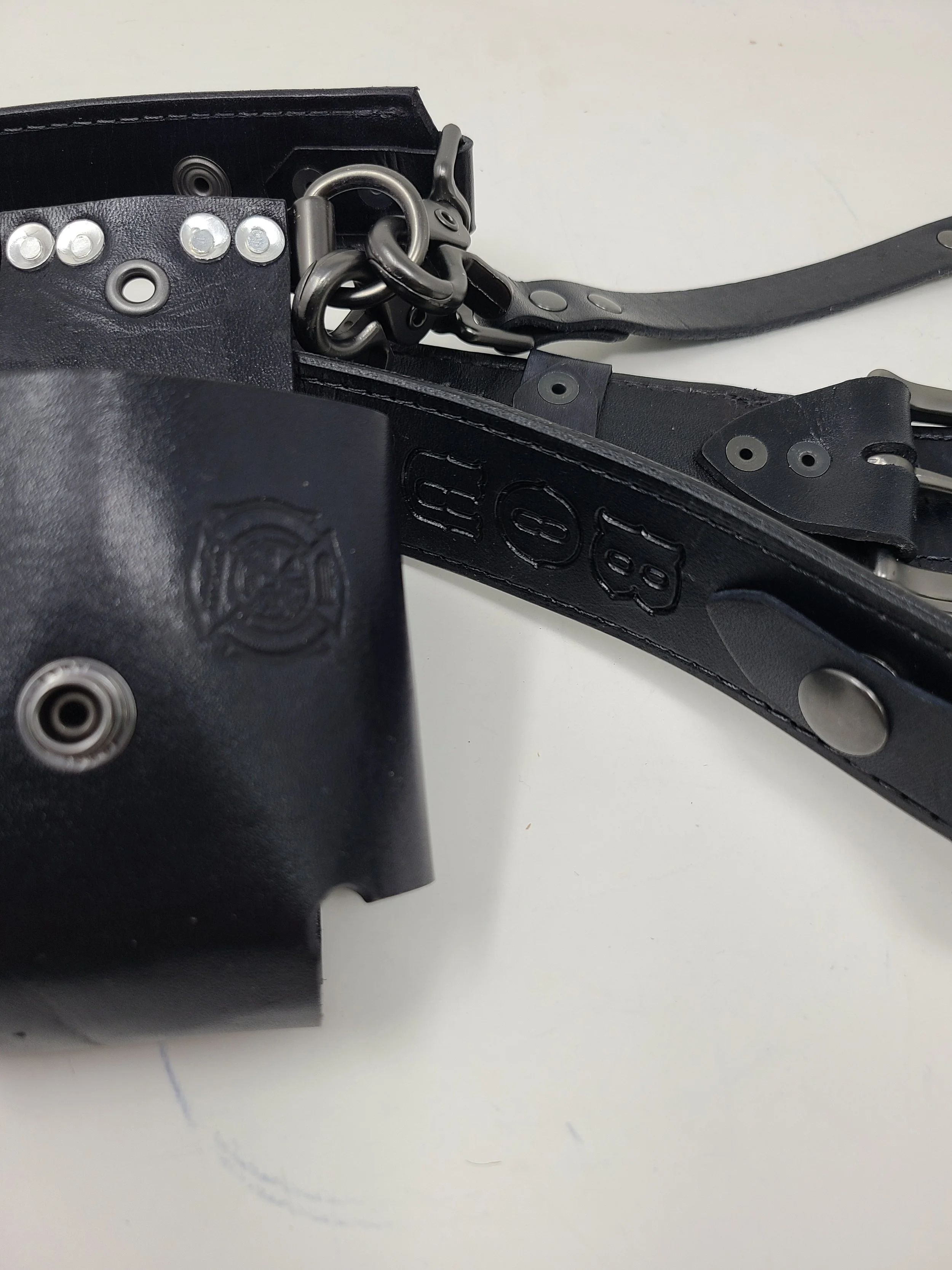 Close-up of an Awl Star Leather radio harness showing full-grain leather, stitching, rivets and metal hardware.