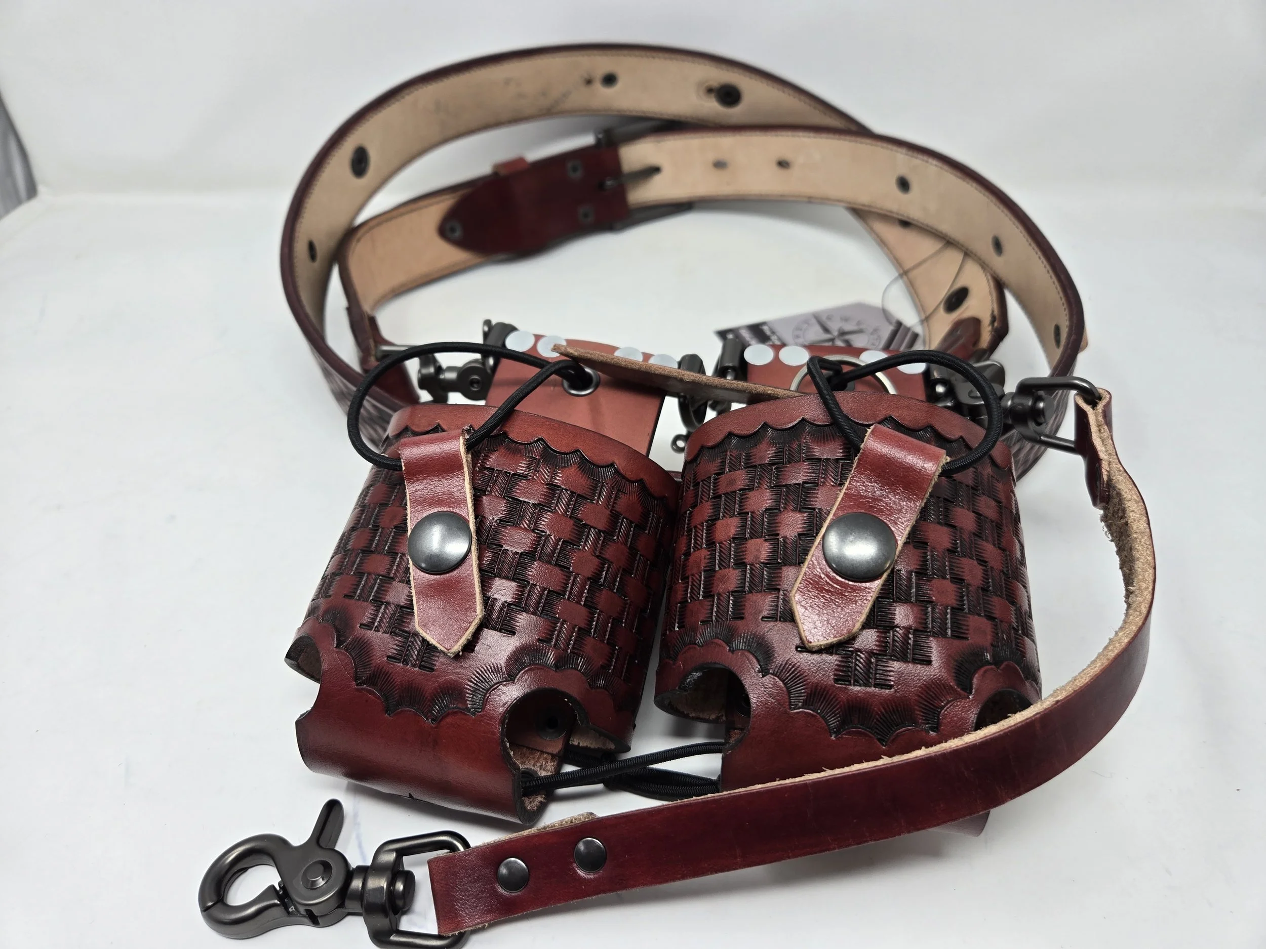 Custom red leather Awl Star Leather radio harness with decorative tooling and metal hardware.