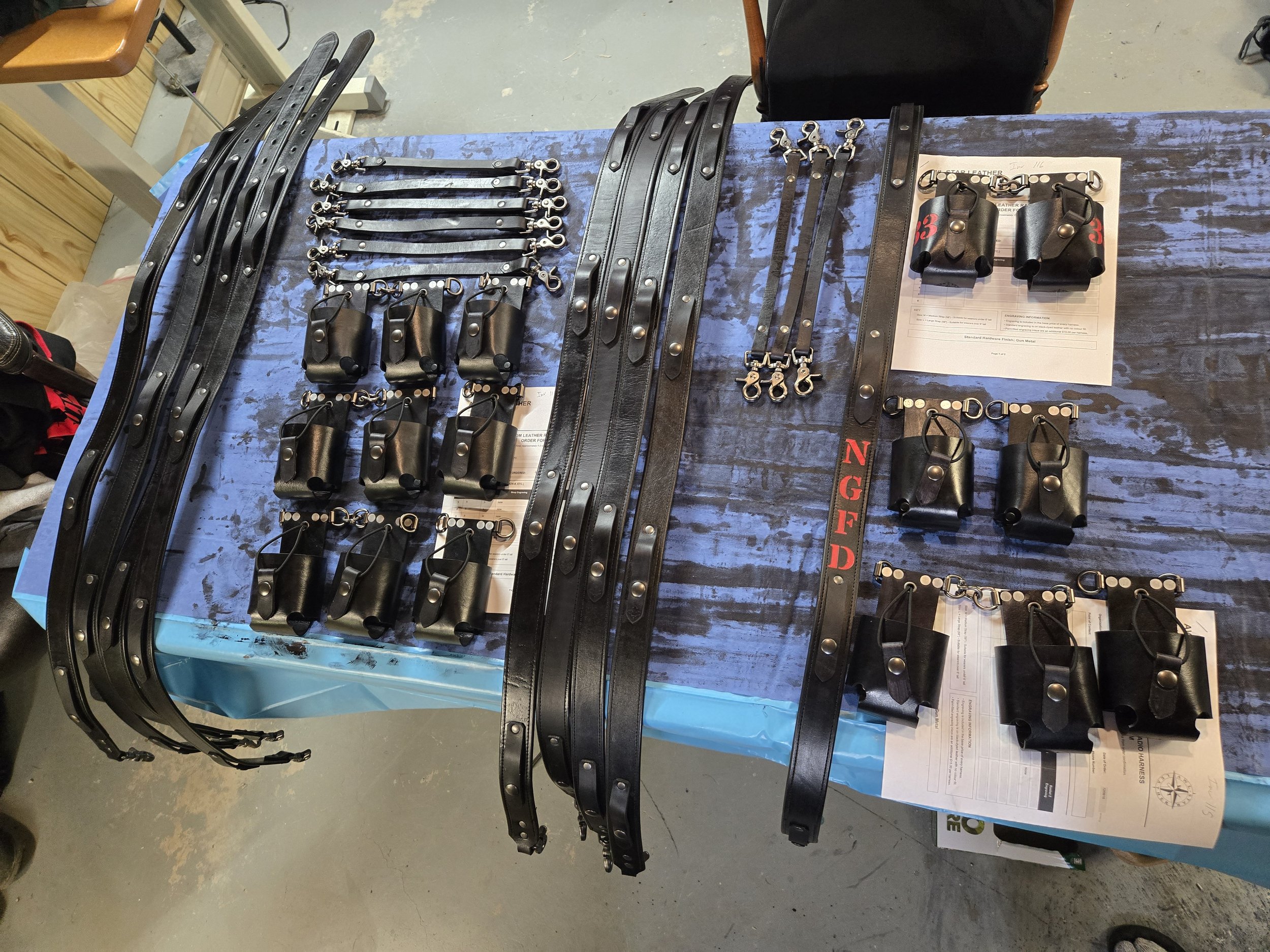 Awl Star Leather radio harness components and leatherwork laid out during production.
