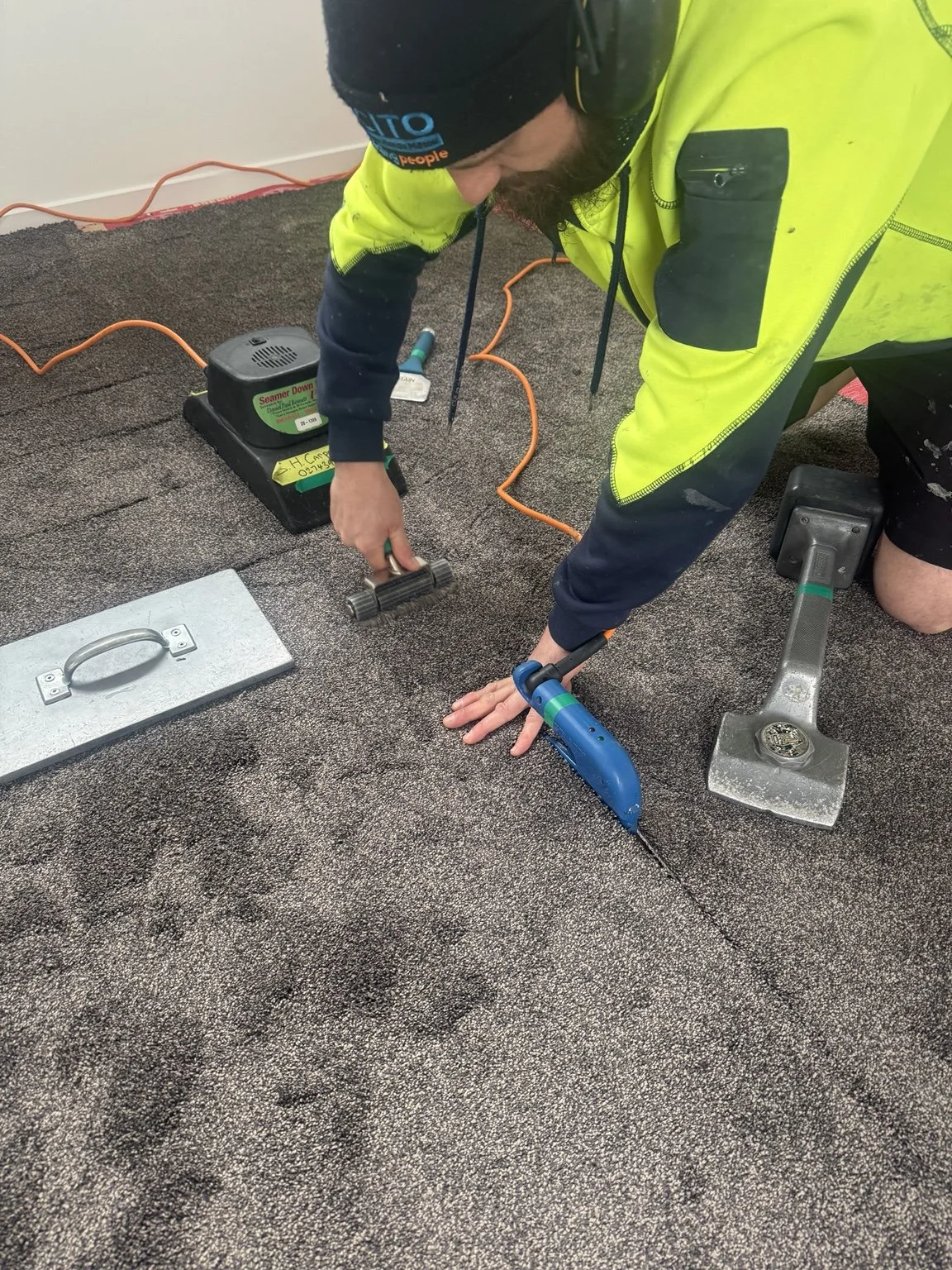 Elliot working on a carpet join during a residential installation