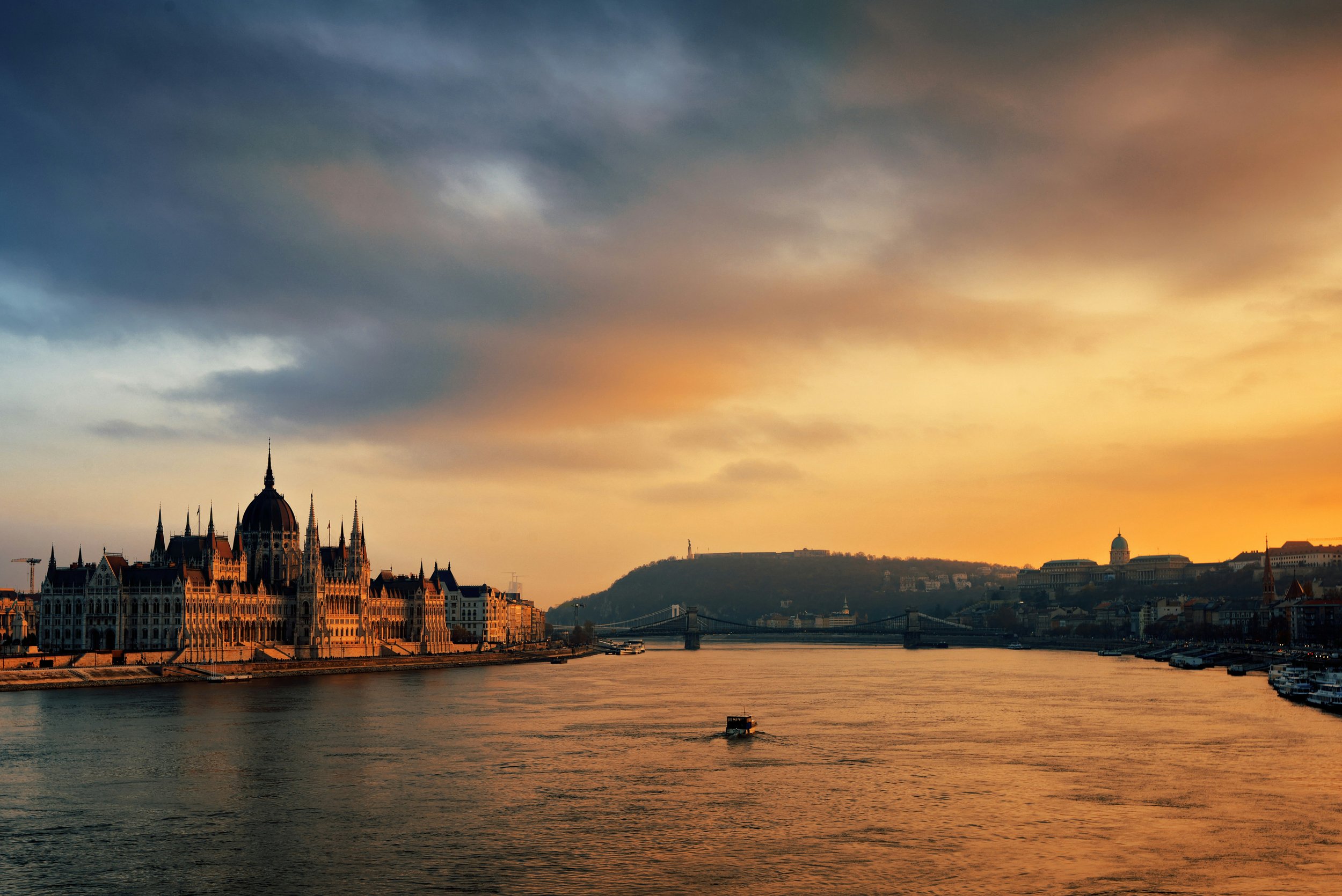 Budapest image: Sunset over the Danube River in Budapest near the Hungarian Parliament Building.