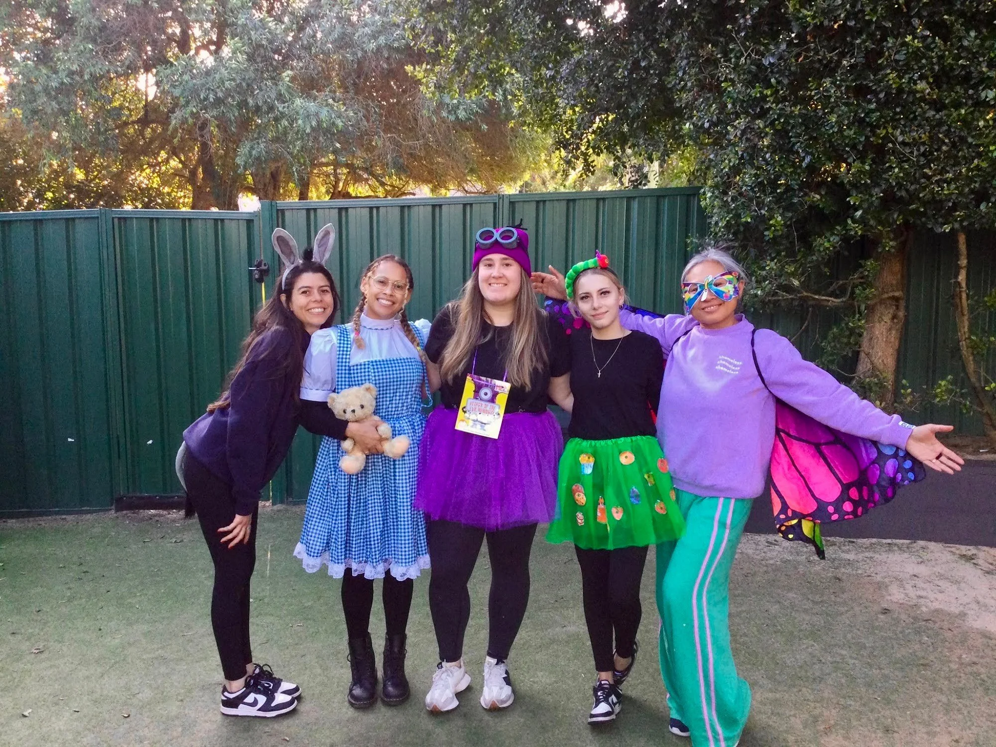Smiling First Class educators dressed up in costumes
