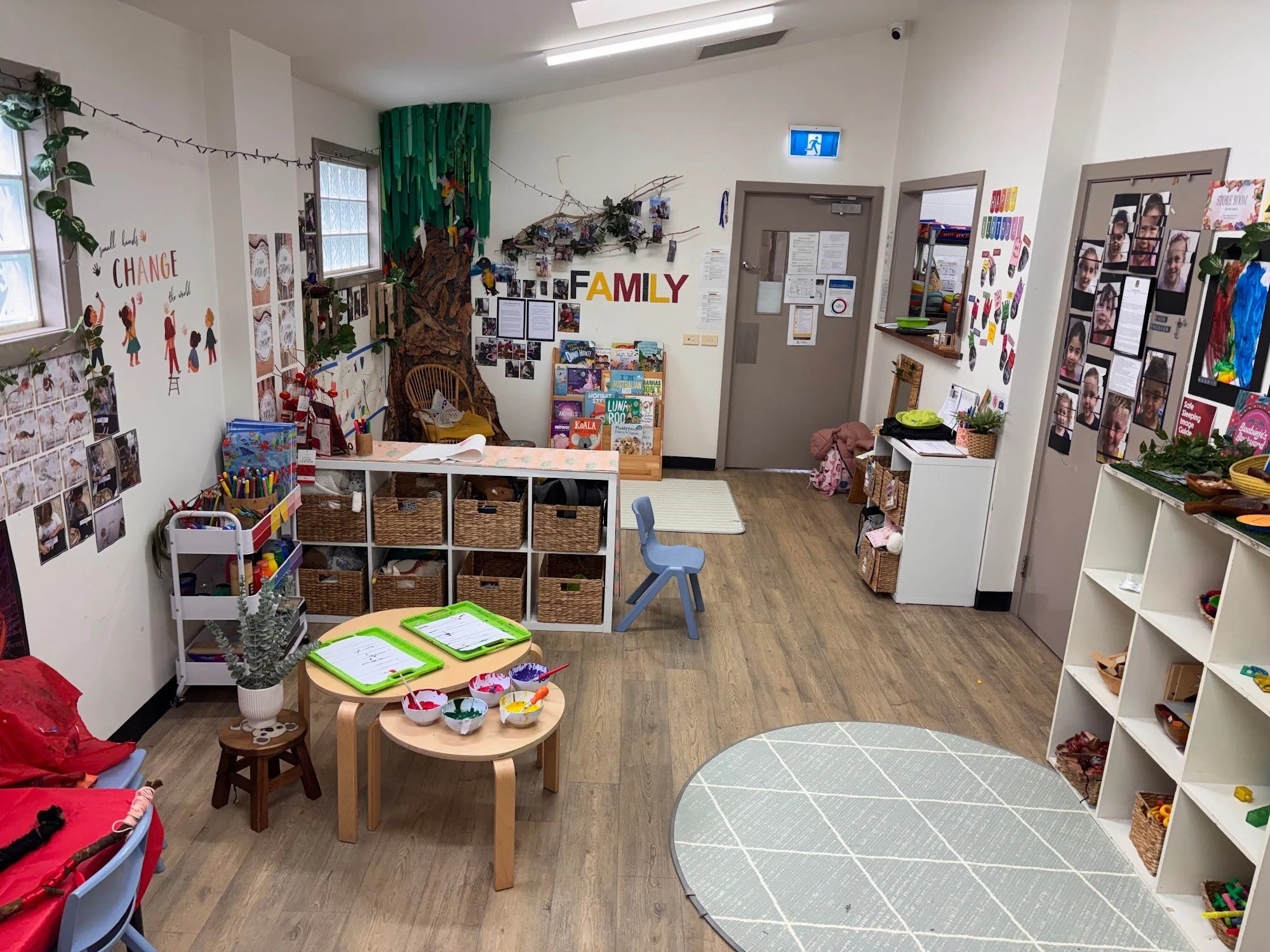 Bright classroom with play tables, shelves and learning materials