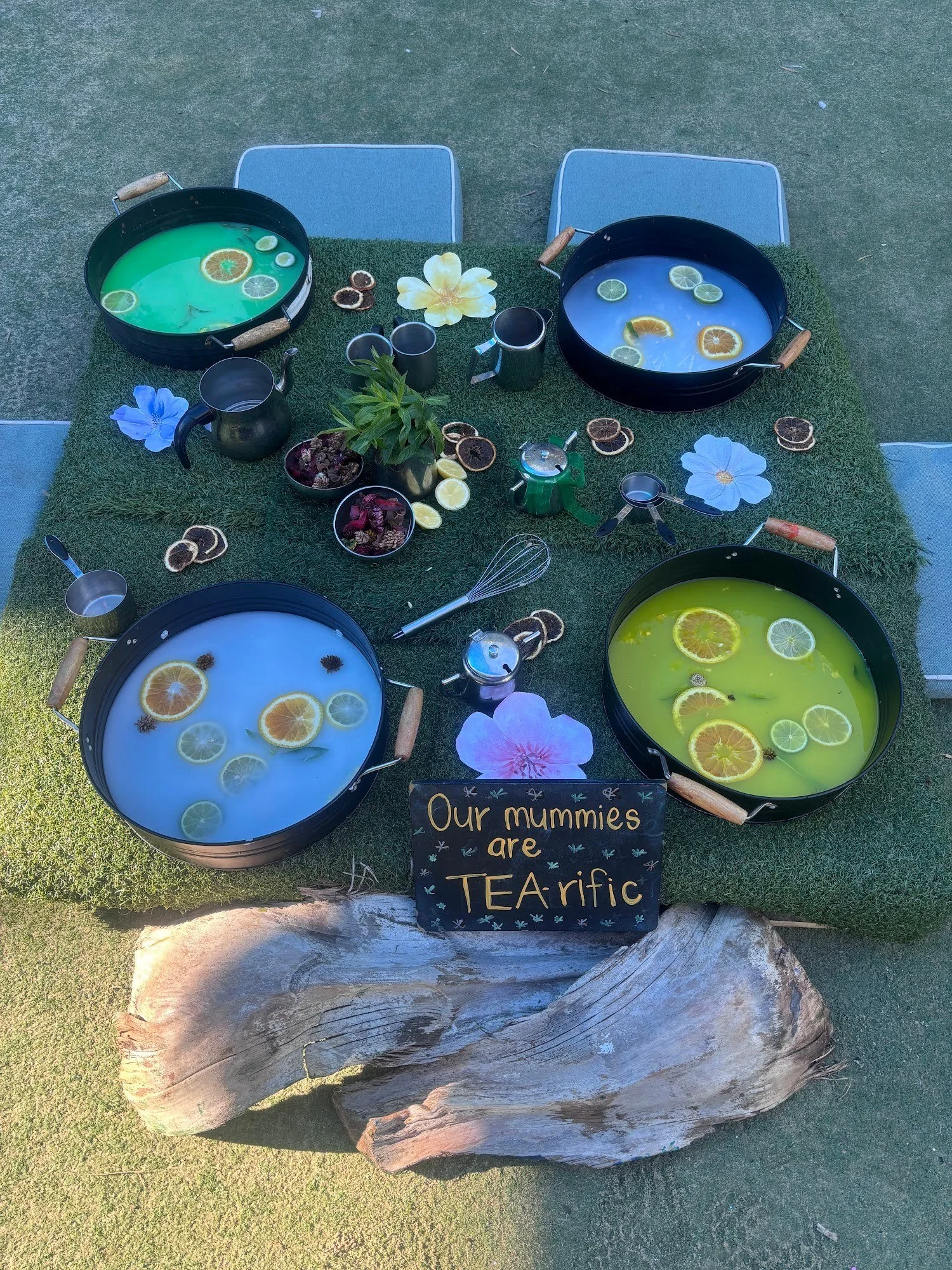 Sensory tea party play tray with water bowls and natural materials