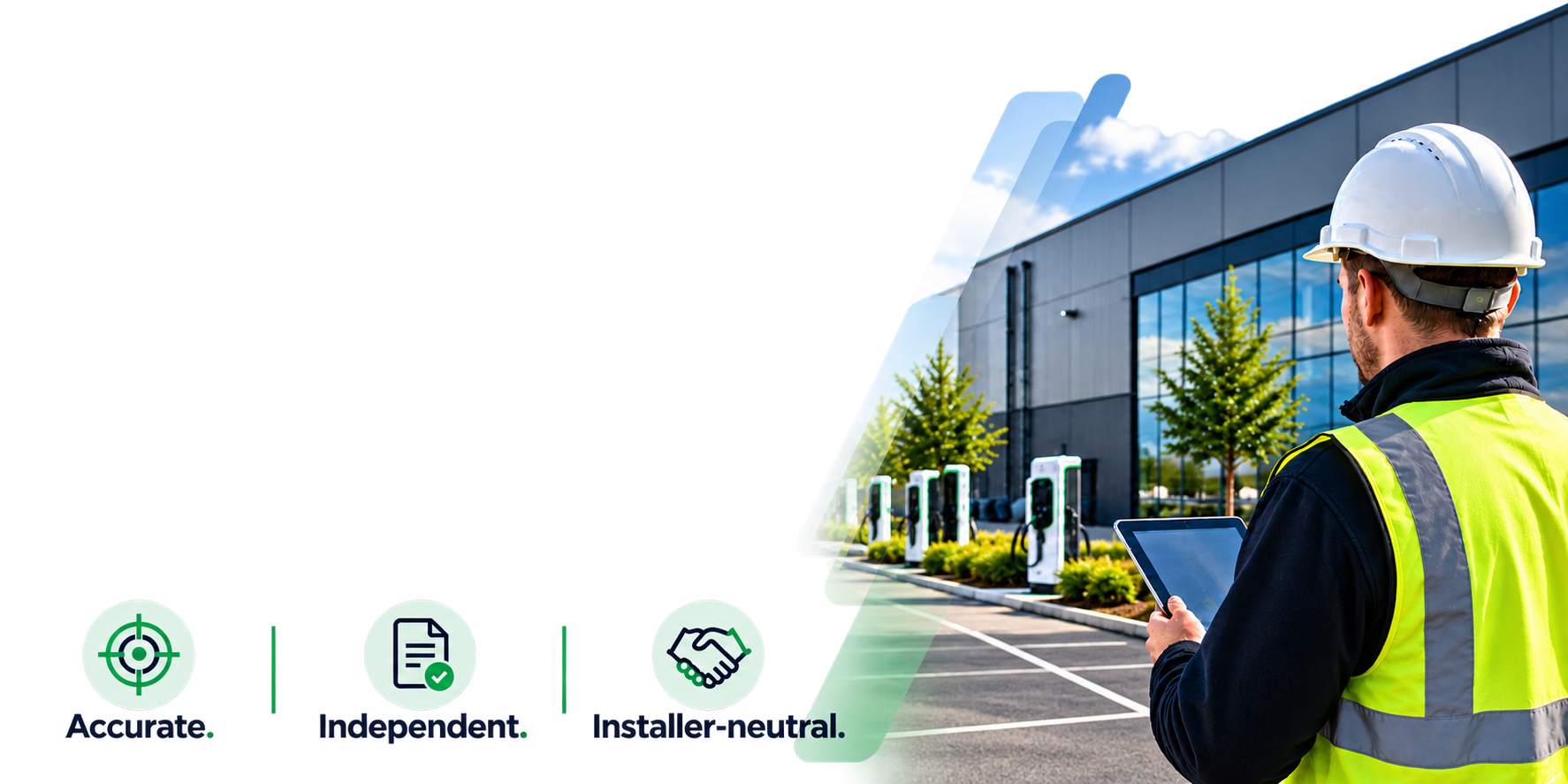 A technician wearing a white safety helmet and yellow safety vest stands outside of a modern, glass-fronted building with green trees and electric vehicle charging stations. The technician is holding a tablet and appears to be inspecting or monitoring the site.
