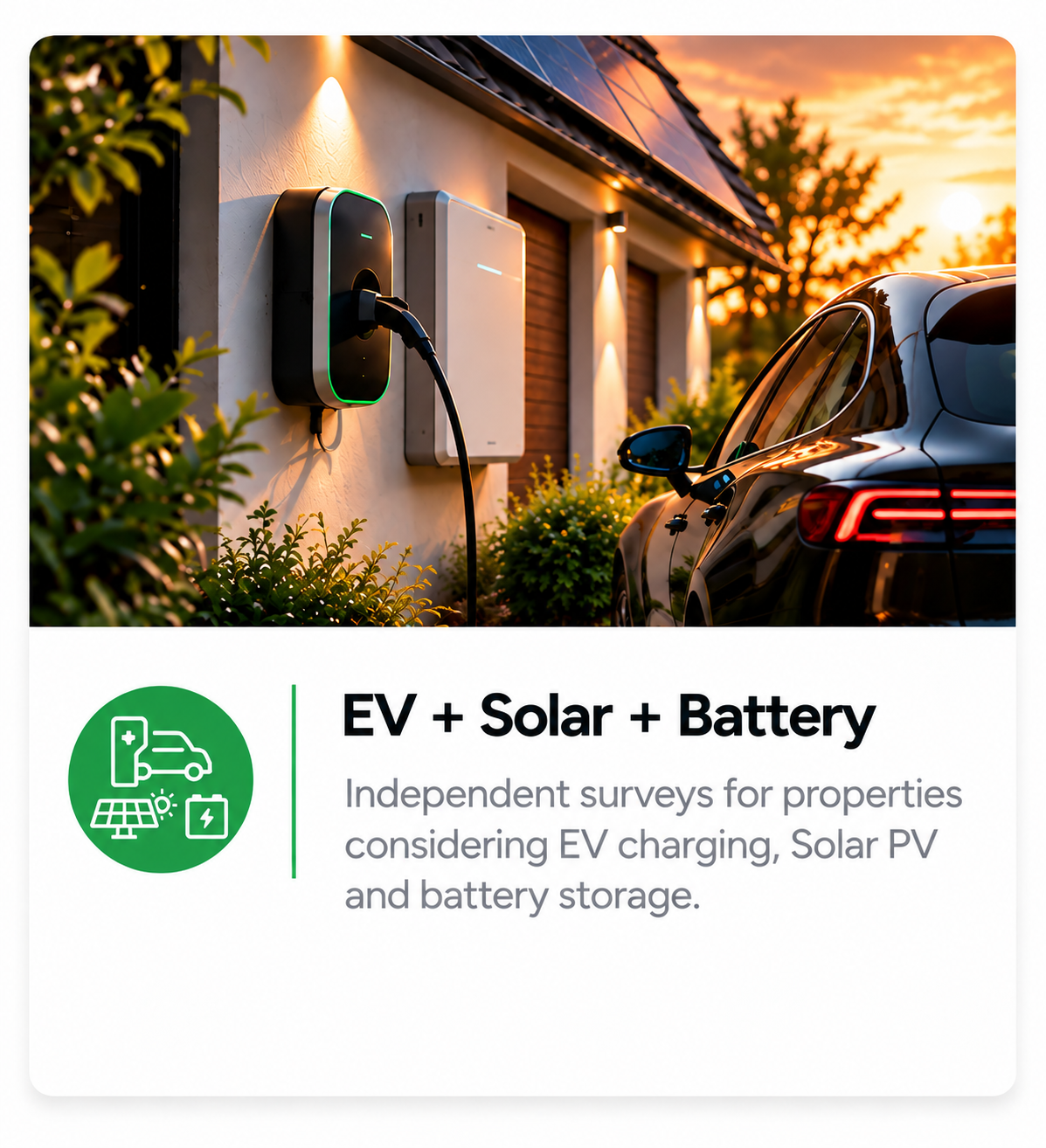 A black electric vehicle is parked next to a wall-mounted EV charger with solar panels on the roof at sunset. The scene shows outdoor lighting illuminating the area and nearby bushes.