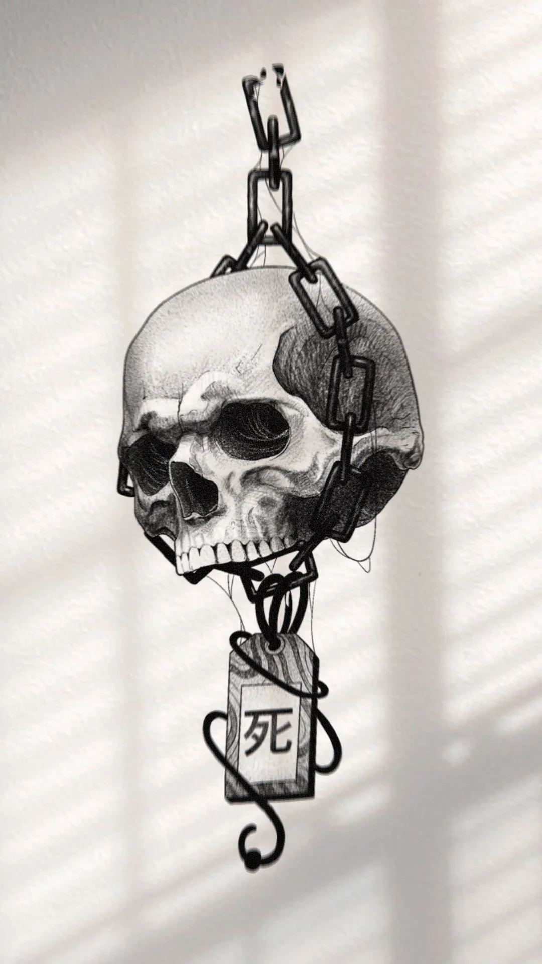 A drawing of a human skull with a chain wrapped around it, hanging with a tag that has Japanese characters for 'death' on it.