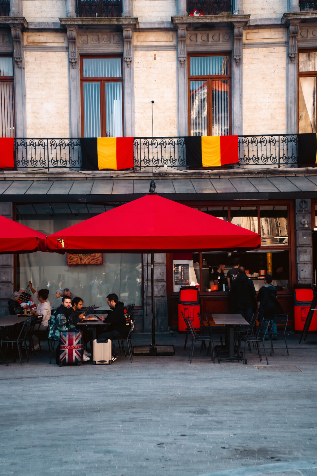 Belgian flags above an outdoor café