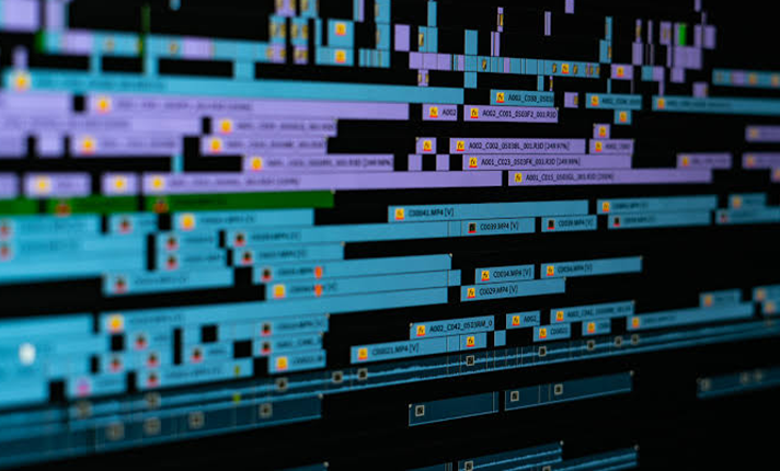 Computer screen displaying a complex digital code or data visualization with lines of colorful code and icons.