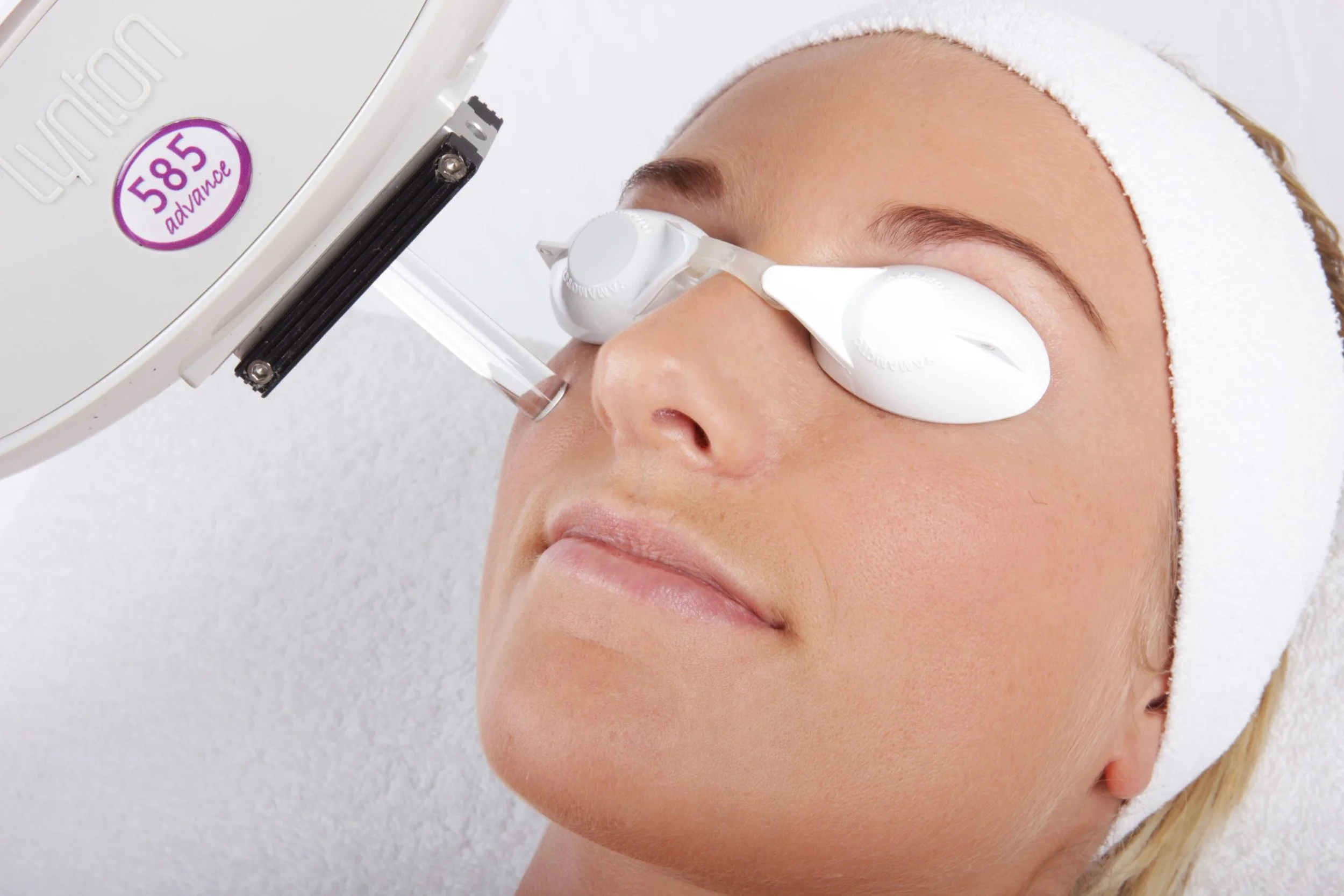 client receiving skin rejuvenation treatment with laser handset