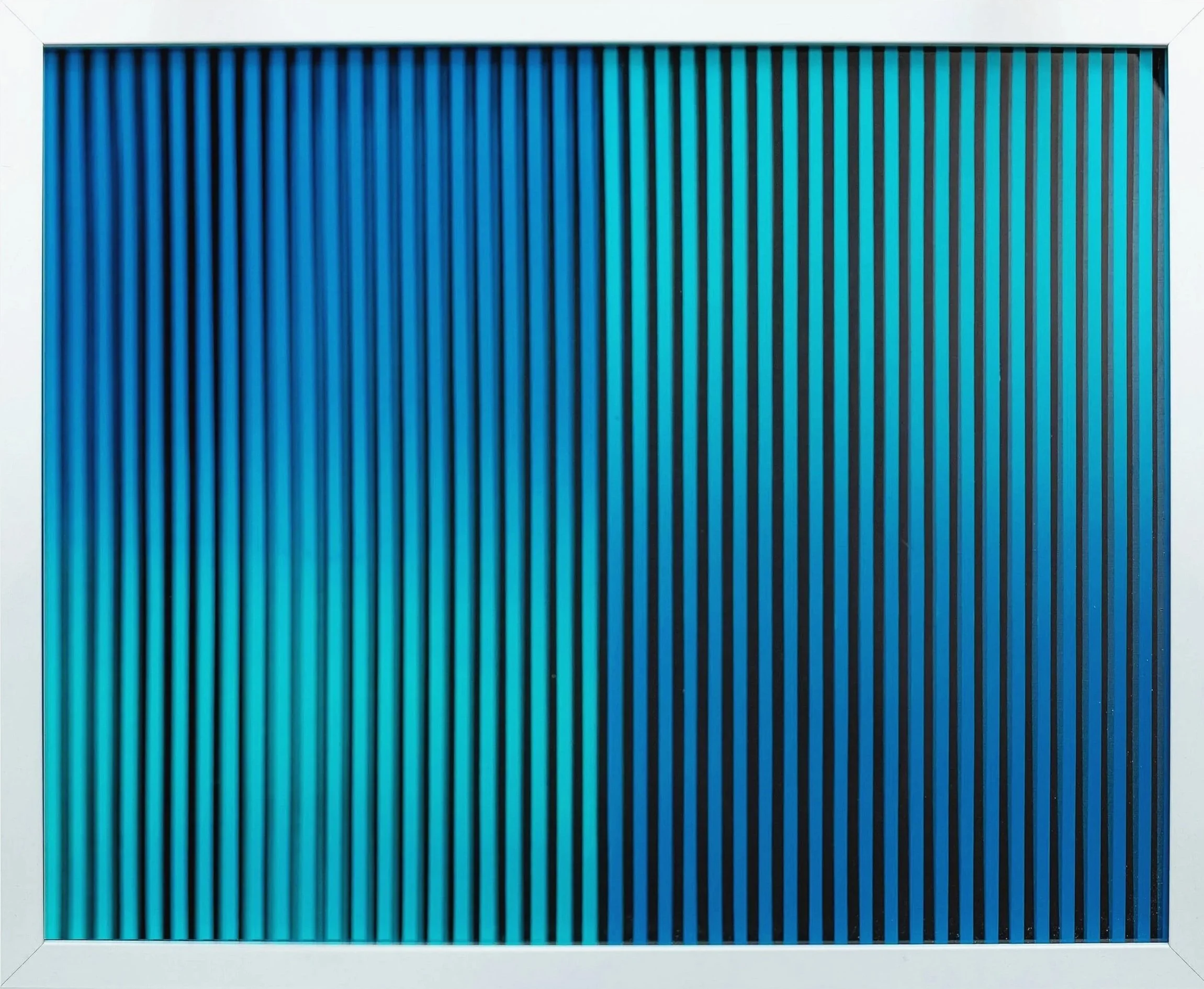 Close-up of a rectangular electronic component with vertical black and blue lines, resembling a microchip or circuit board, framed by a white border.