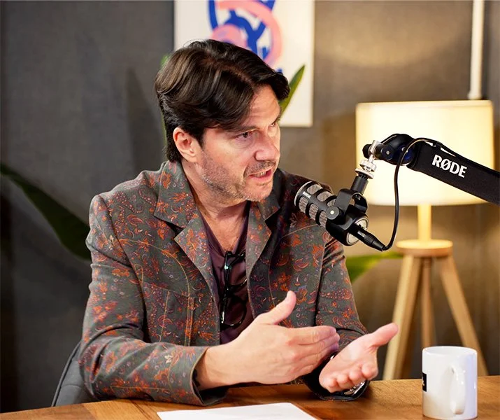 Side shot of Tony Long interviewing a guest.