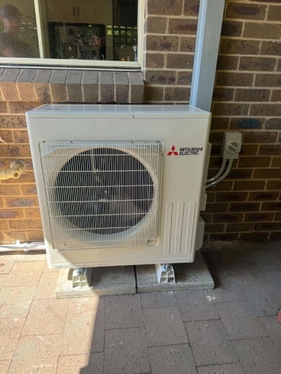 Split system outdoor unit against a brick wall