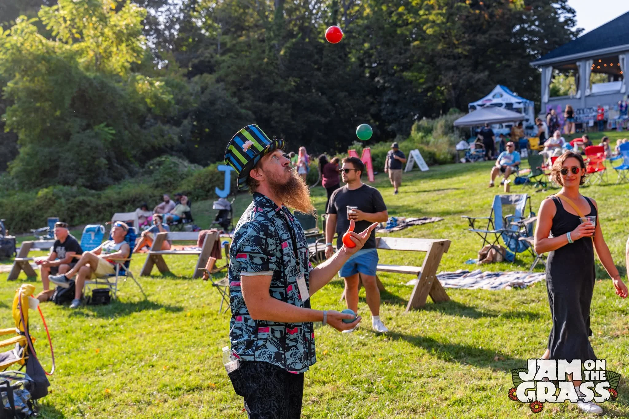 Man juggling at music festival. Jam on the grass in Philadelphia. Photo taken by Kevin Matsanka