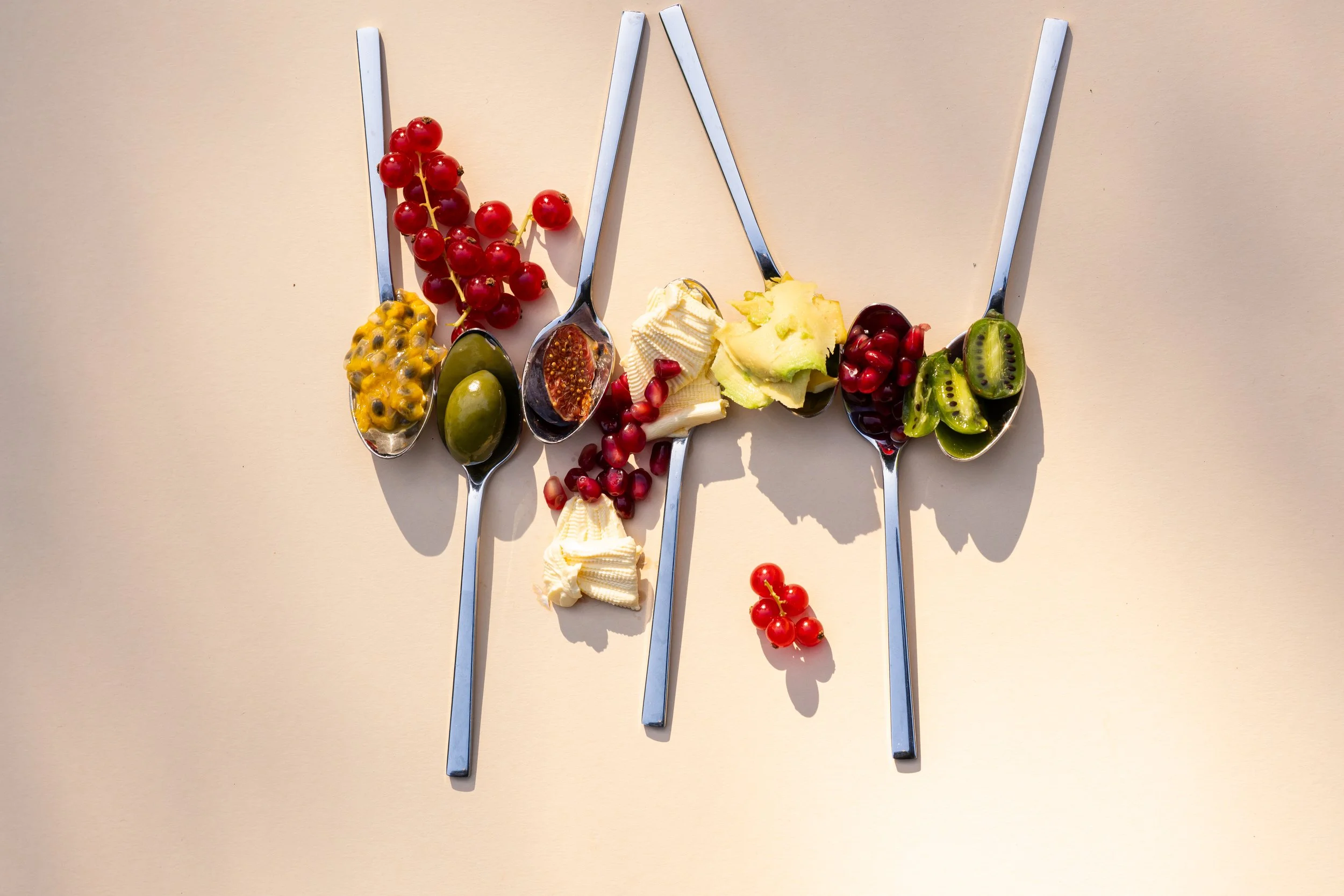 Vijf sleutels met verschillende soorten fruit op de handvatten, waaronder passievrucht, druiven, en kiwi.