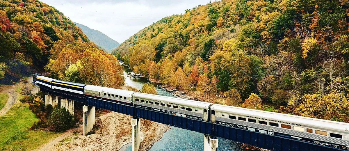 train on Sycamore Bridge crossing the south branch river with Fall colored trees