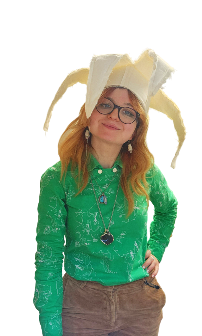 Elisabeth Sur - Costume Designer with red head, smiling wearing an handmade  jester Hat
