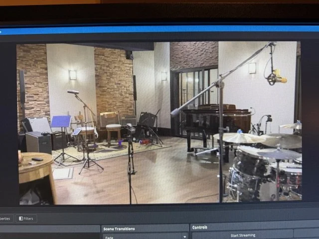 Recording studio with musical instruments, microphones, and sound equipment.