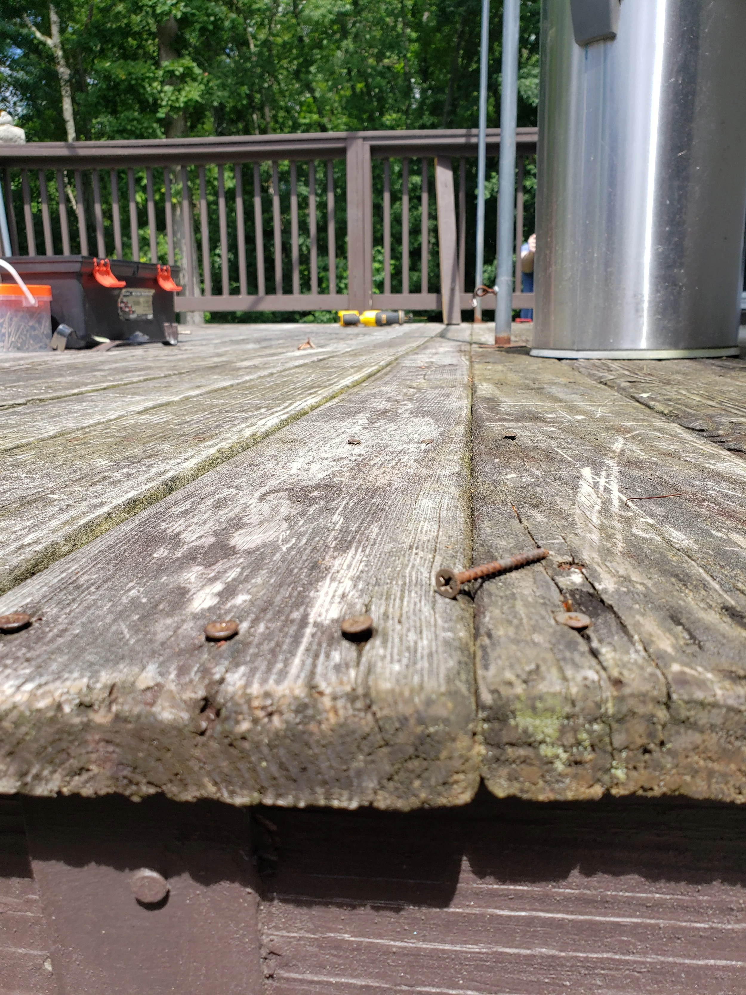 Weathered wooden deck boards before I replaced them.