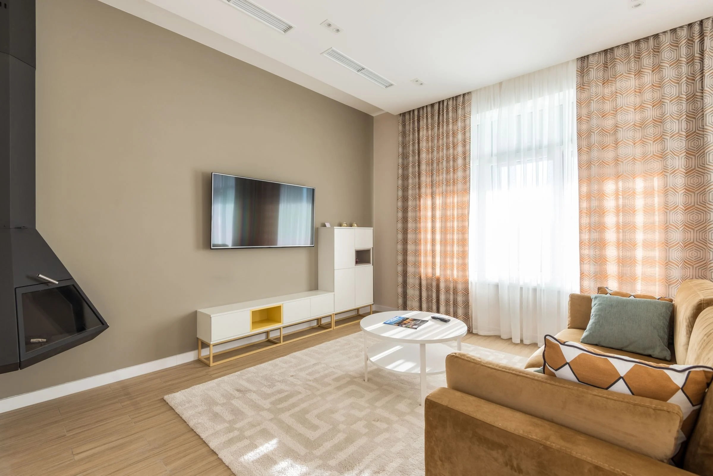 A tidy, bright living room with natural light