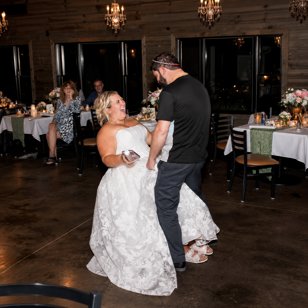 Joyful Wedding Dance Under Chandeliers.png