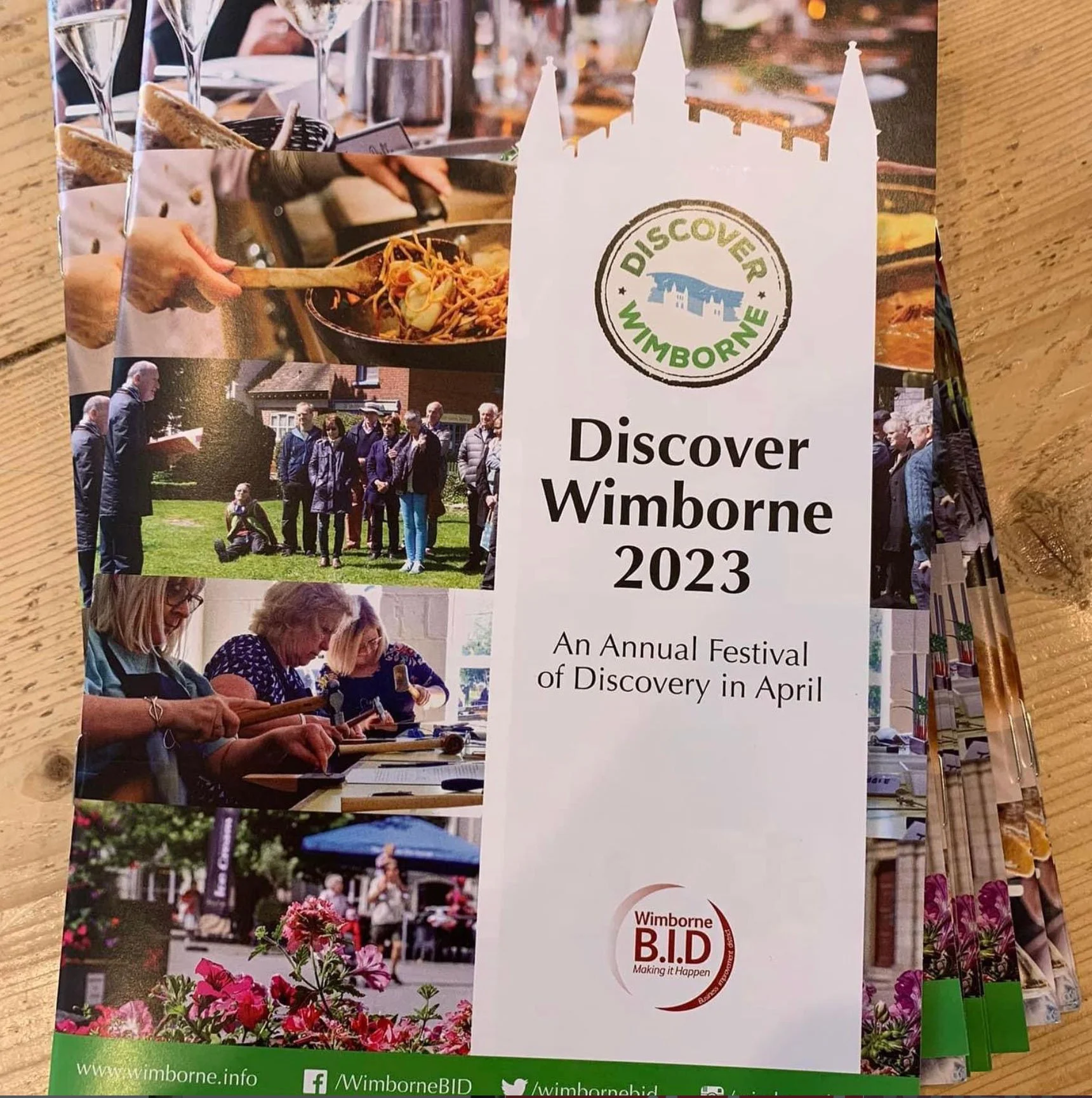 Flyer for the Discover Wimborne 2023 annual festival featuring images of people enjoying food, outdoor activities, and community events in Wimborne, including a group standing on grass, people using smartphones, and flowers.