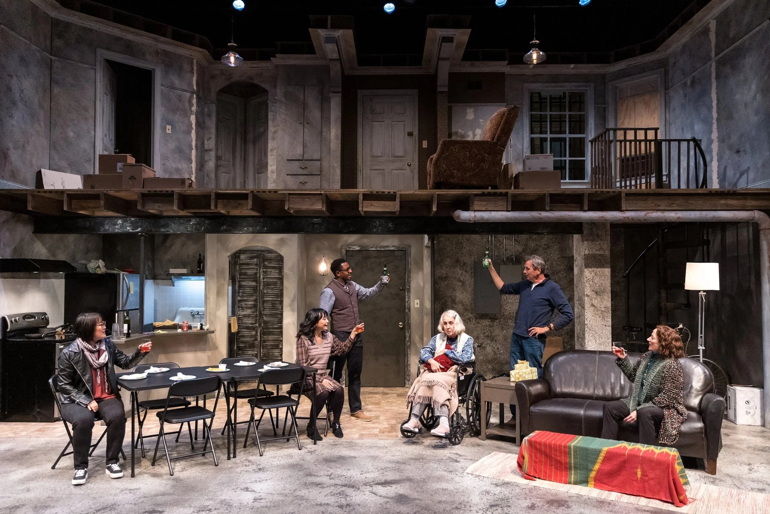 The family raises a toast on the two-level apartment set of The Humans, Park Square Theatre, 2022. Lighting by Karin Olson.