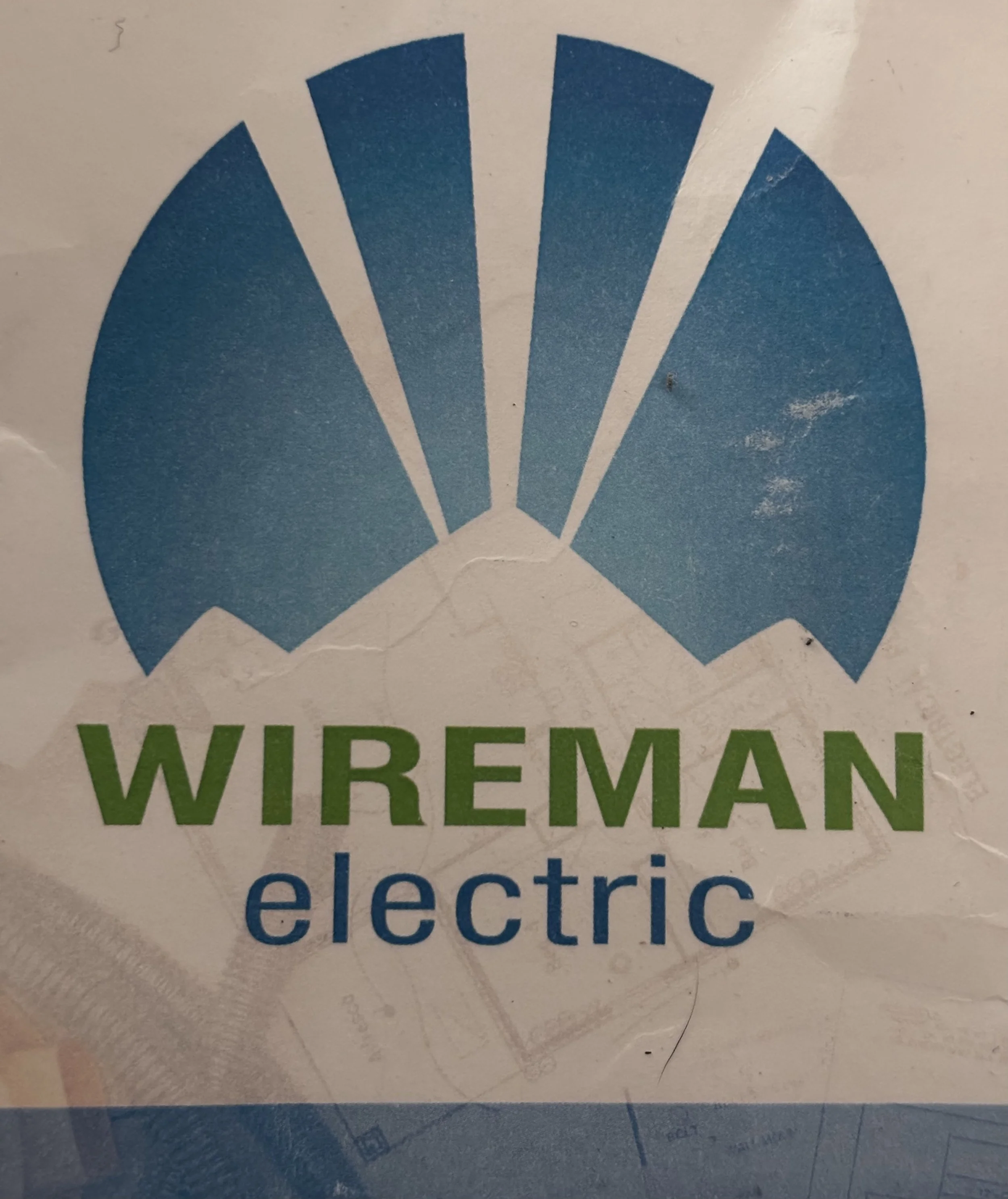 Logo with blue and green design featuring the words 'Wiremaman electric'