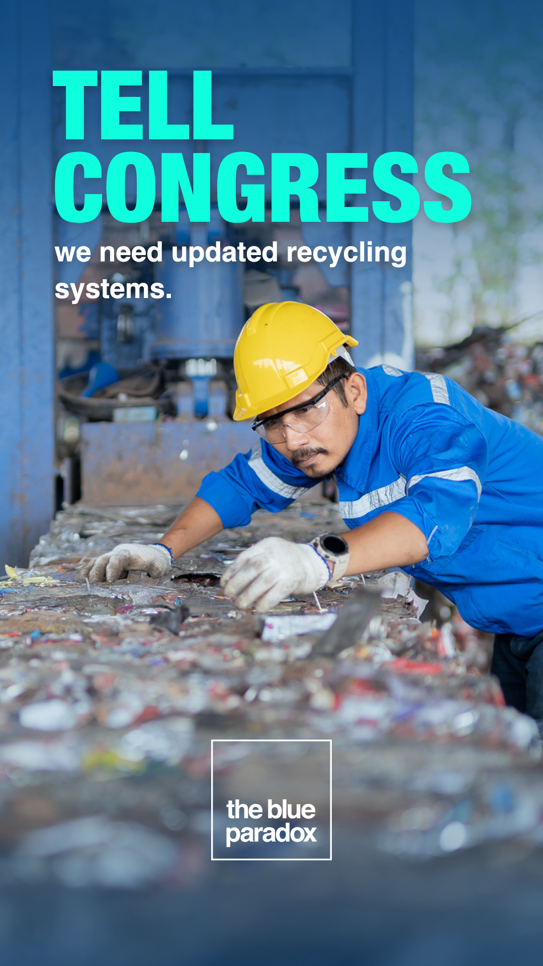 A worker in blue uniform and yellow safety helmet sorting through a pile of mixed waste at a recycling facility.