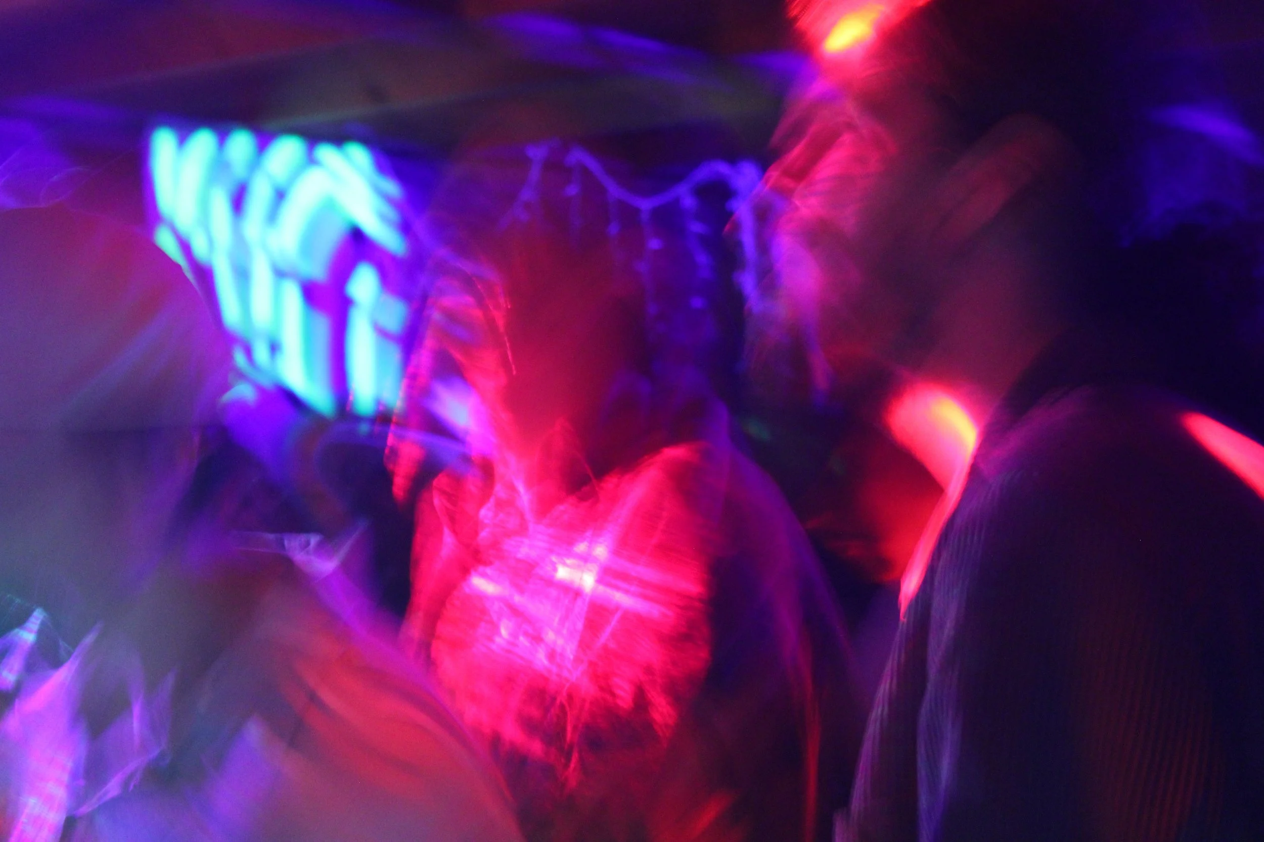 Abstract scene with vibrant, swirling neon lights in colors of blue, pink, purple, and yellow