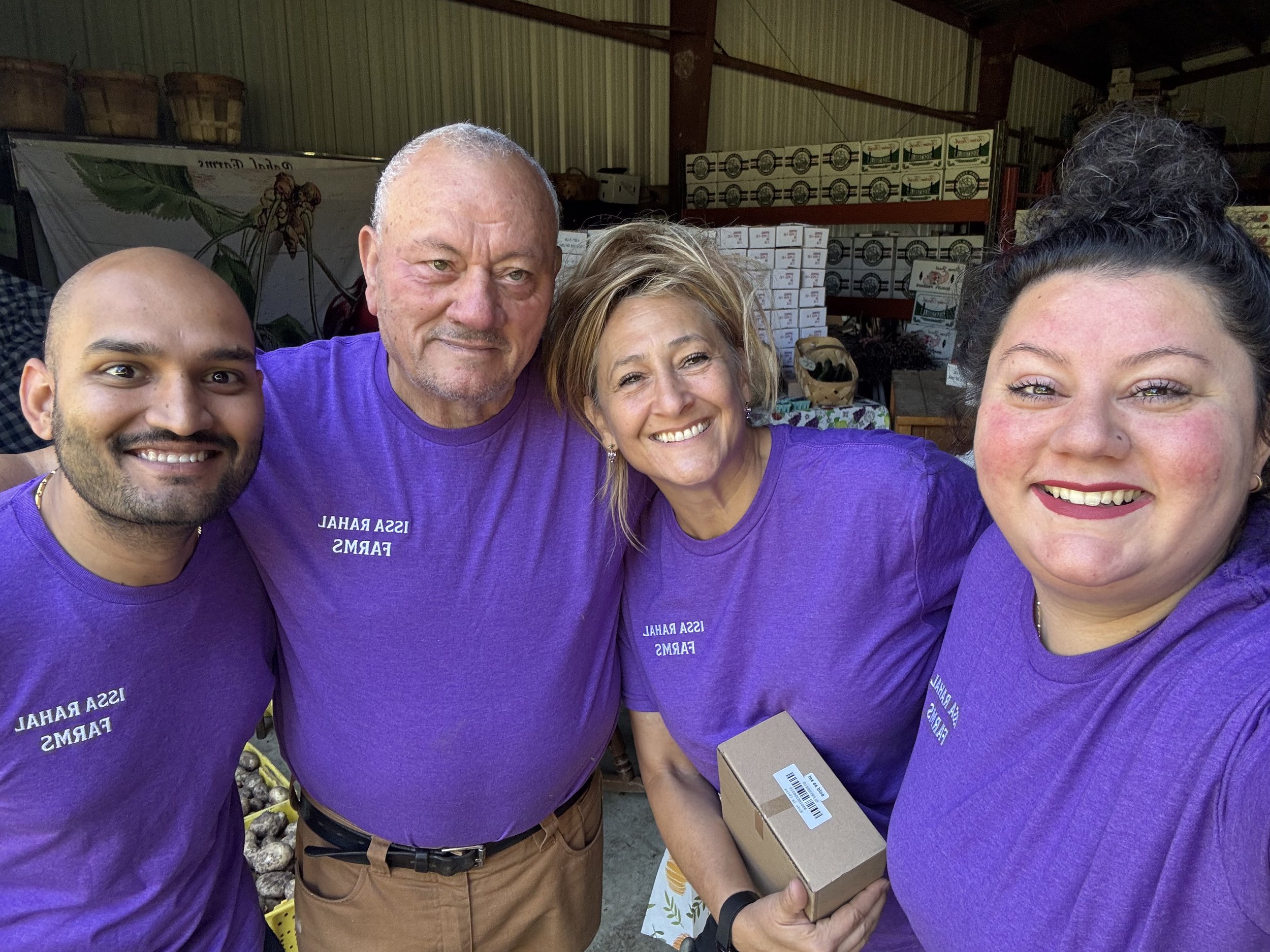 group photo volunteers purple shirts warehouse market.jpeg