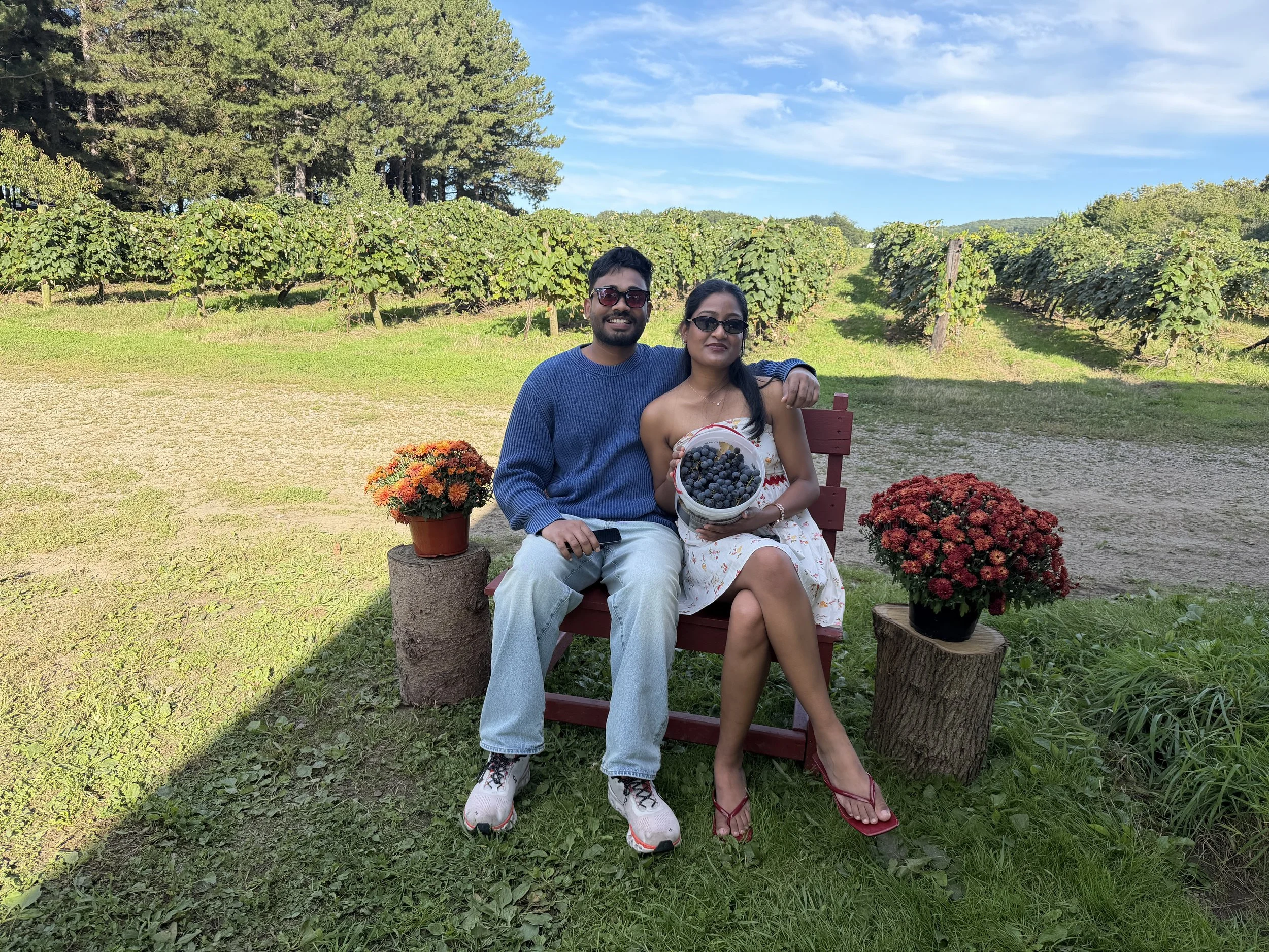 couple at vineyard bench with grapes.jpeg