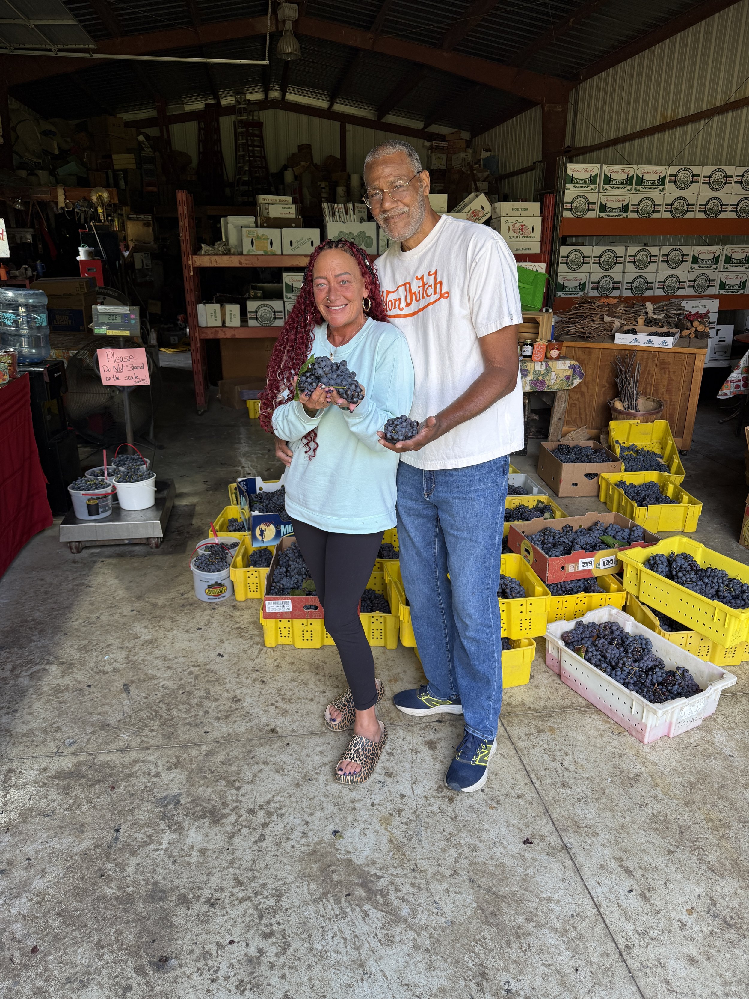 couple holding grapes in warehouse market.jpeg