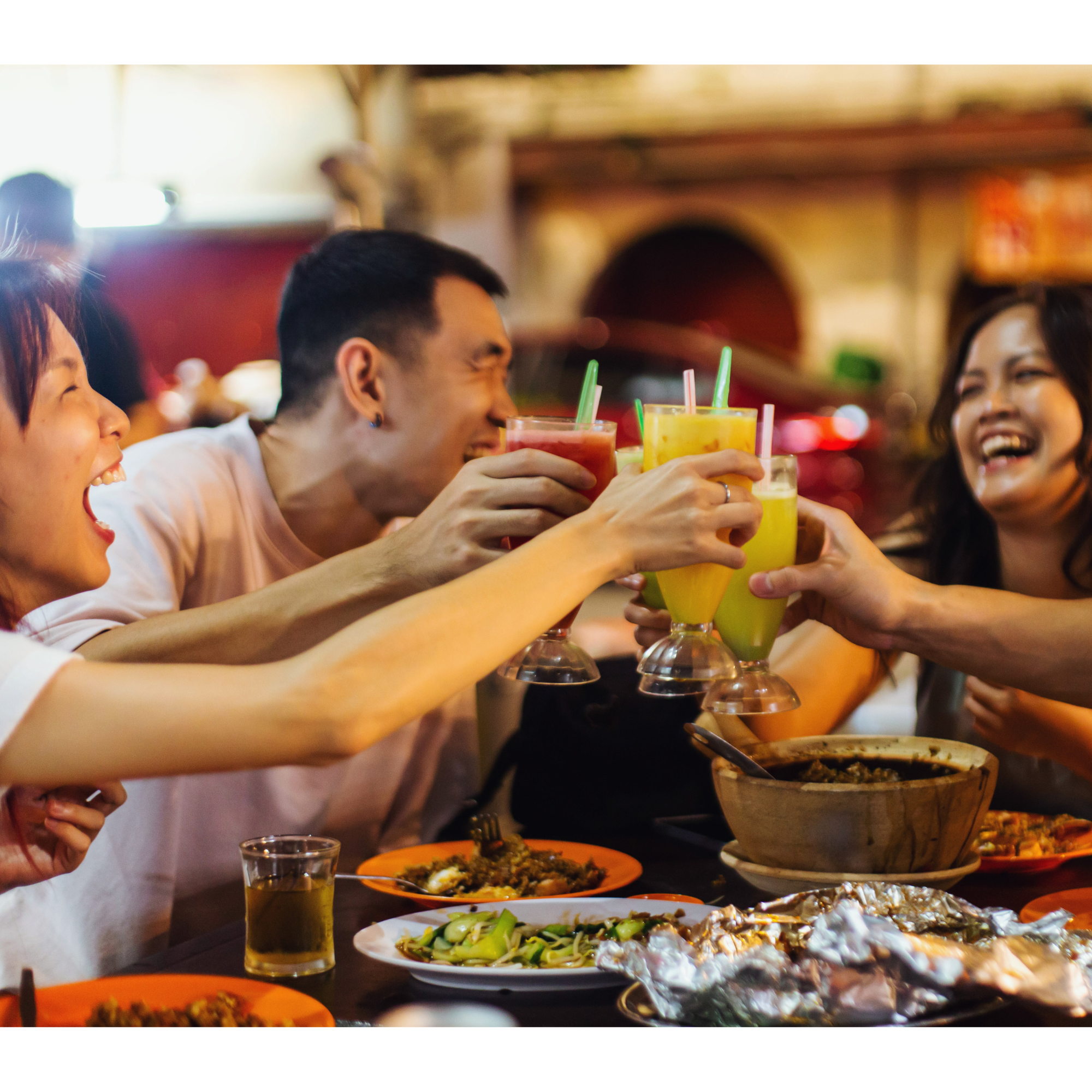 People enjoying drinks and a variety of dishes at a social gathering or celebration.