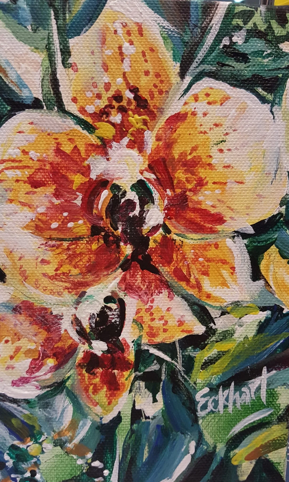 An abstract painting of a large orange and yellow flower with green leaves, created with bold brushstrokes and splashes of paint.